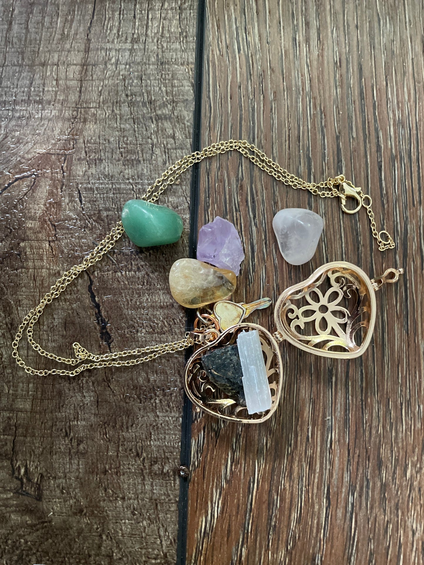 Gold locket filled with crystals on 16+” gold chain