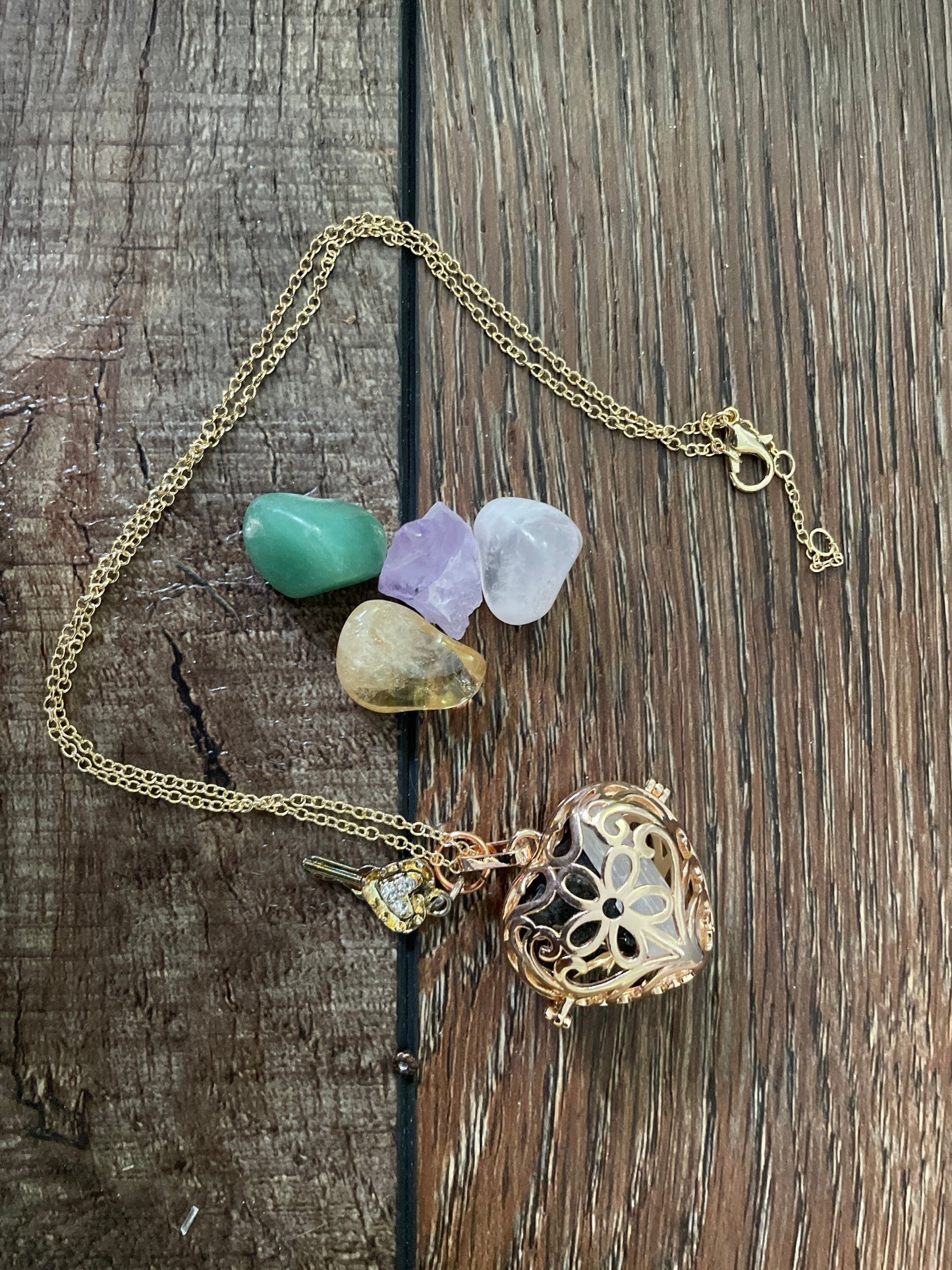 Gold locket filled with crystals on 16+” gold chain