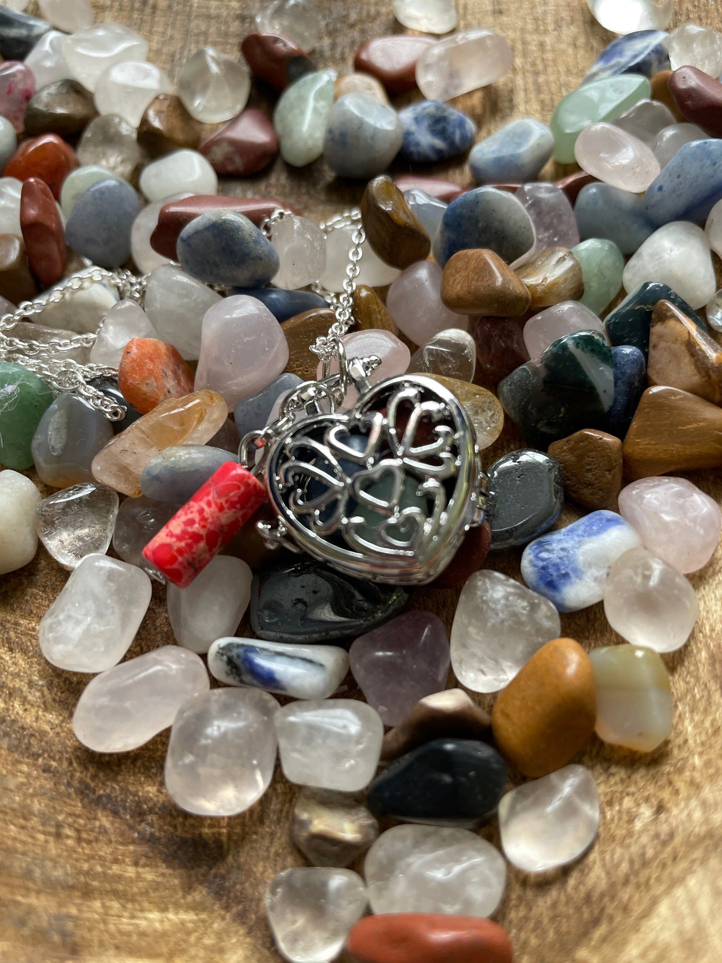 Silver stainless steel locket filled with crystals on 16+” silver stainless steel chain