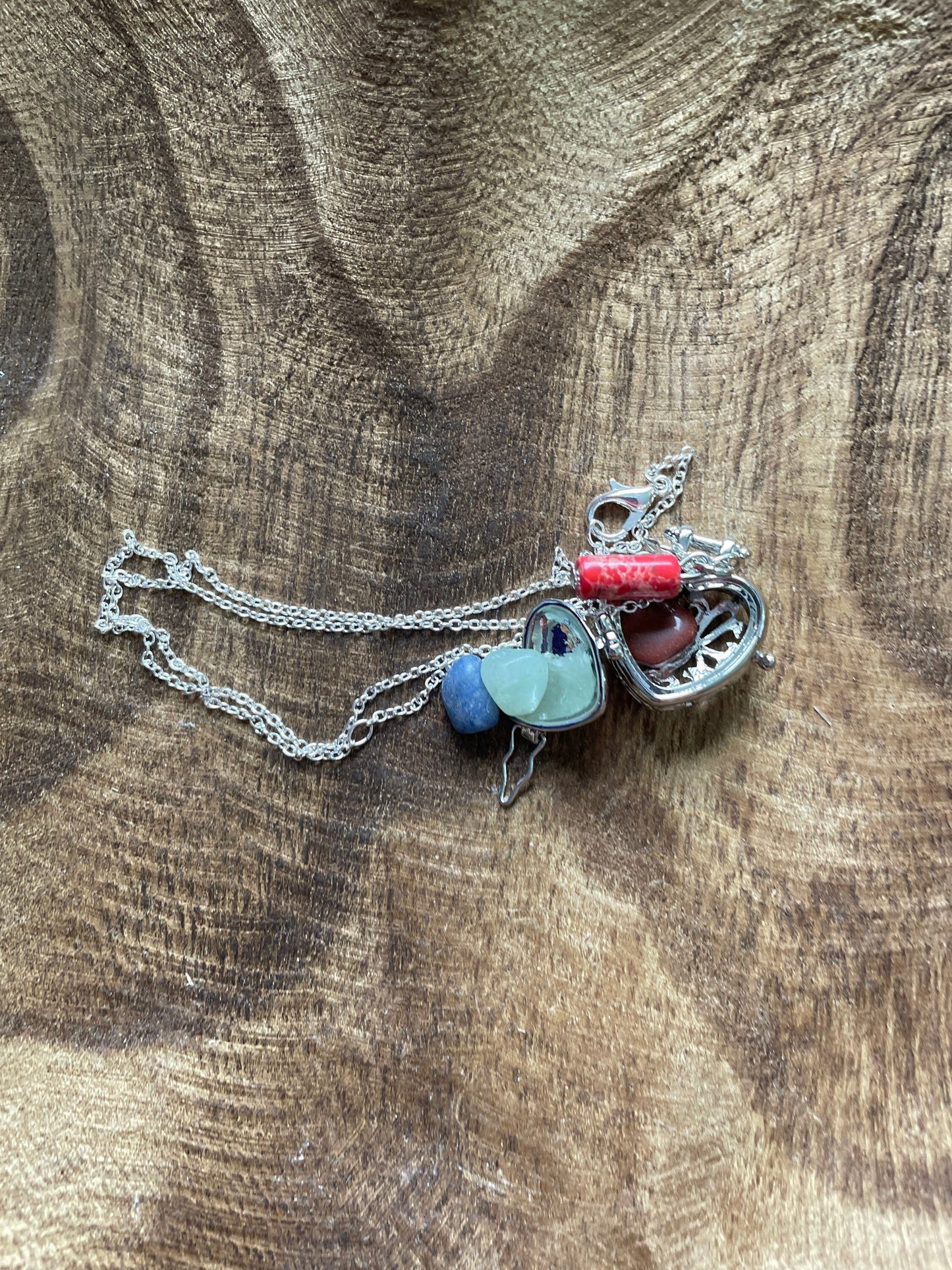 Silver stainless steel locket filled with crystals on 16+” silver stainless steel chain