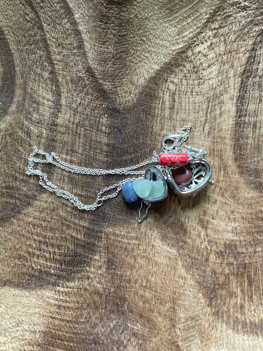 Silver stainless steel locket filled with crystals on 16+” silver stainless steel chain