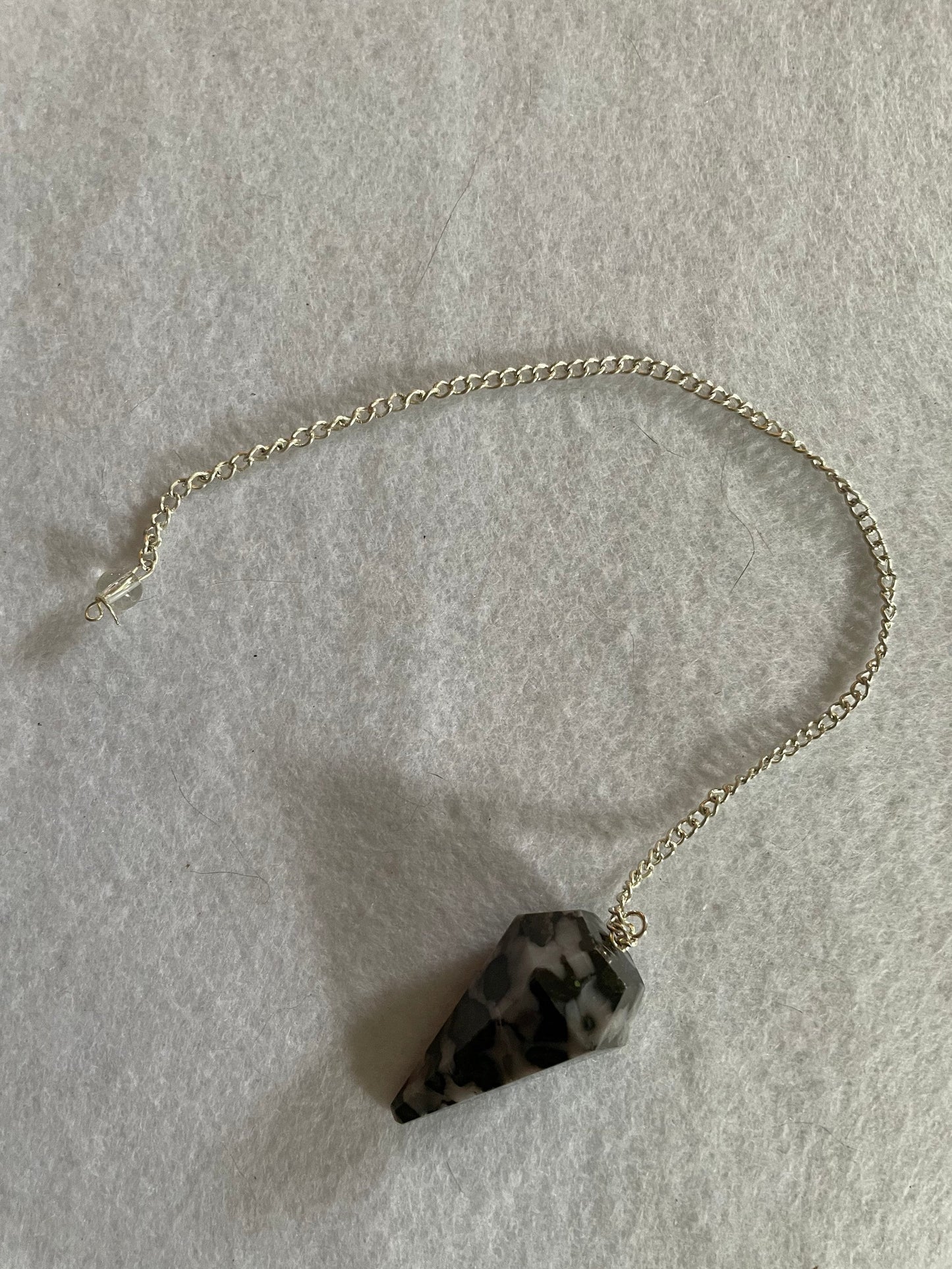 This beautiful Gabbro pendulum is approximately 1.5” and with chain is 9.5” total length.