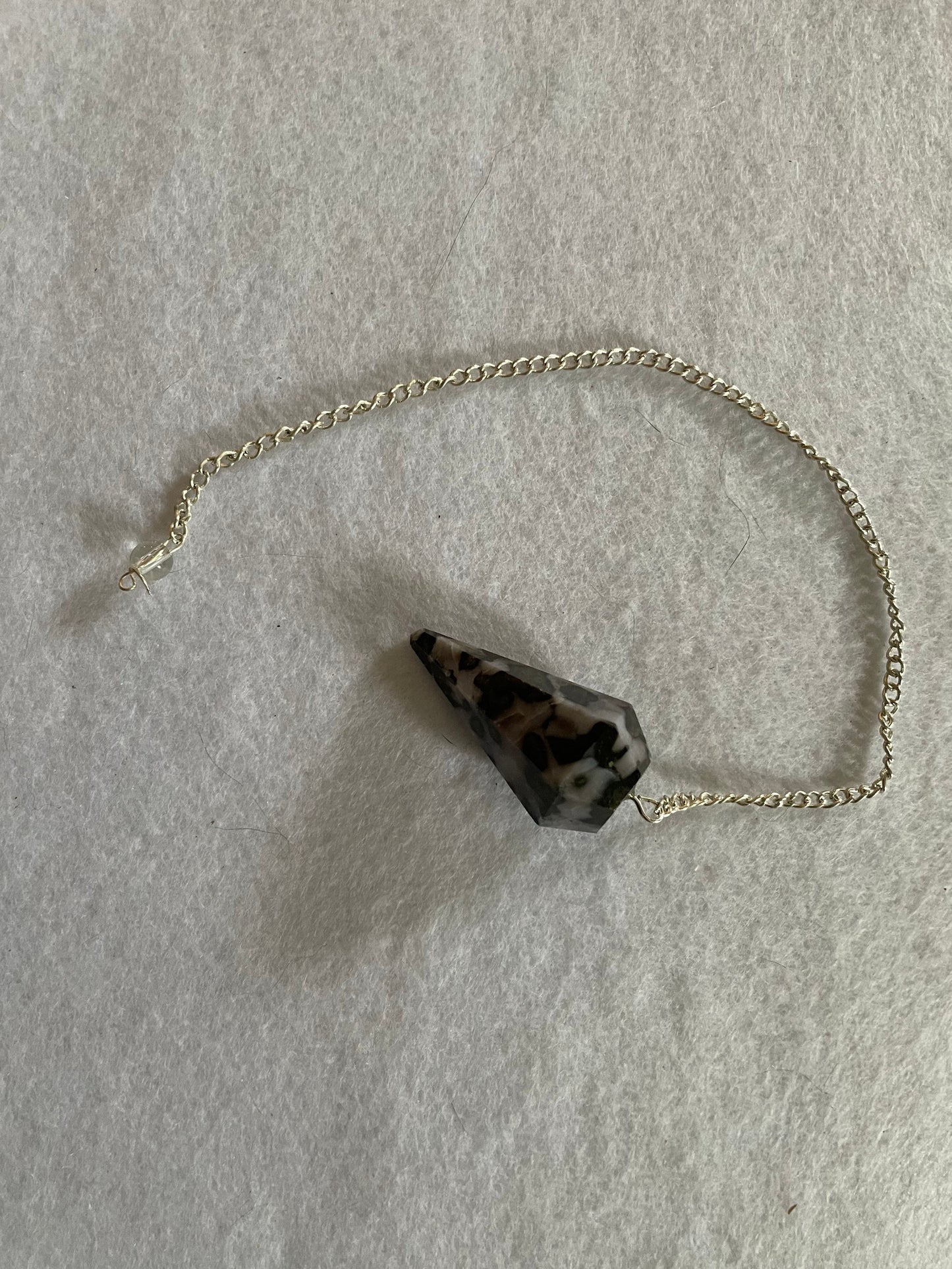 This beautiful Gabbro pendulum is approximately 1.5” and with chain is 9.5” total length.