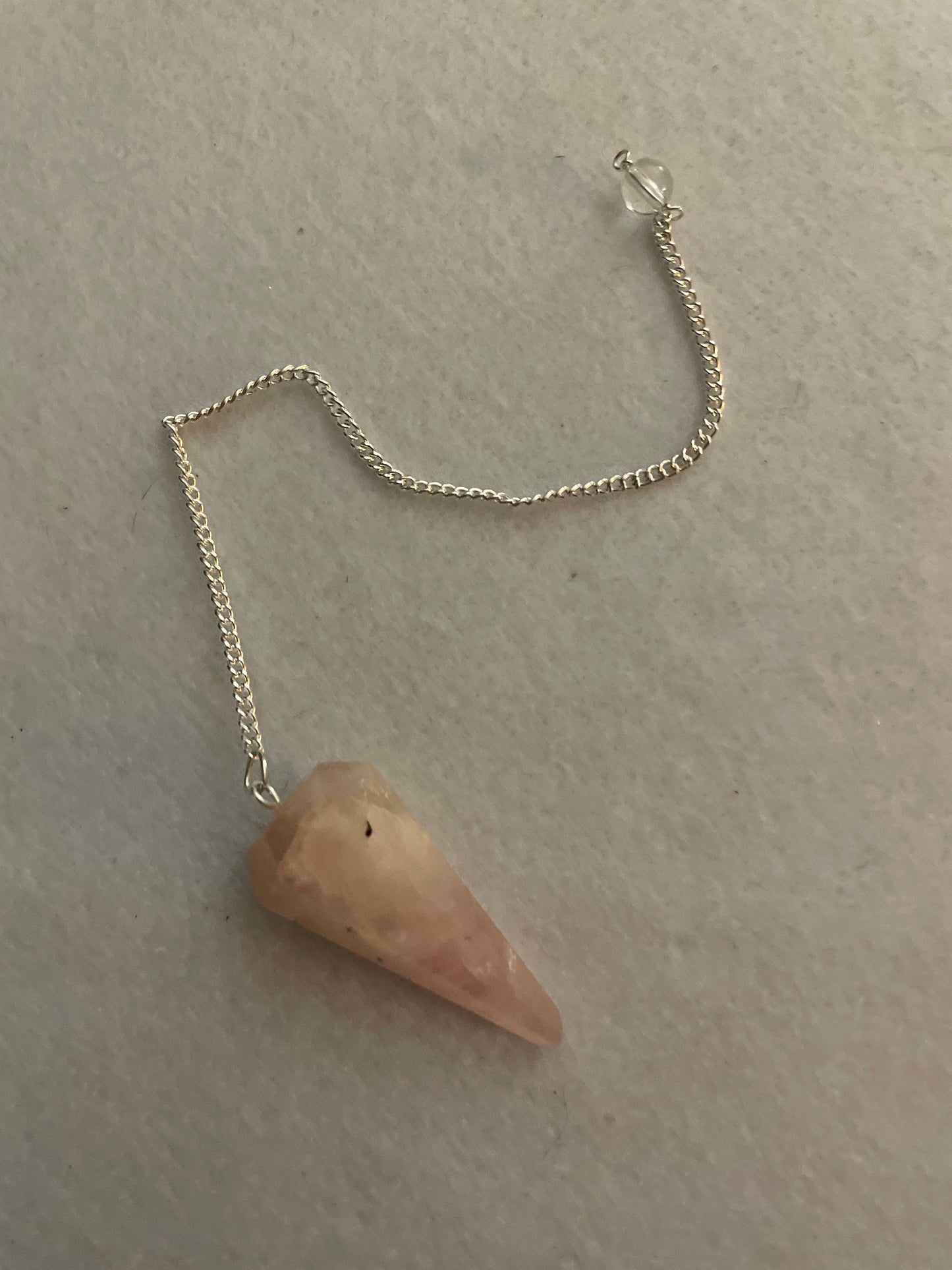 This beautiful Rose Quartz Pendulum is 1.65” and with chain is 8”