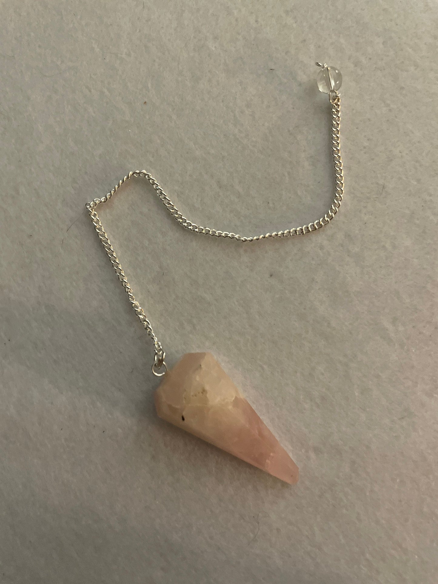This beautiful Rose Quartz Pendulum is 1.65” and with chain is 8”