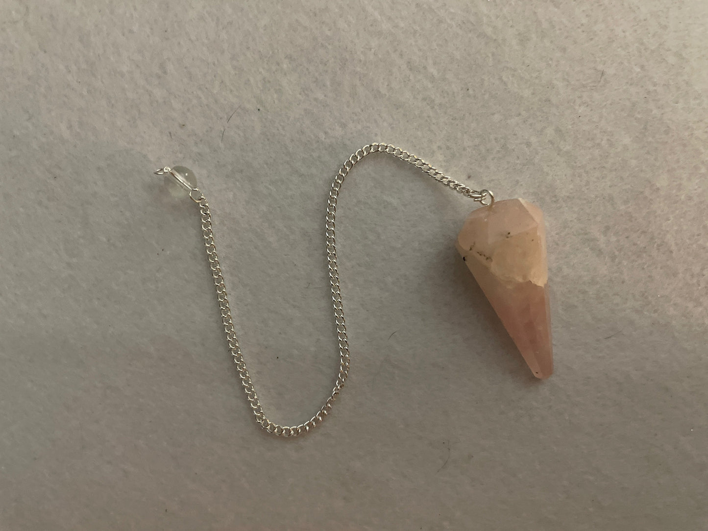 This beautiful Rose Quartz Pendulum is 1.65” and with chain is 8”