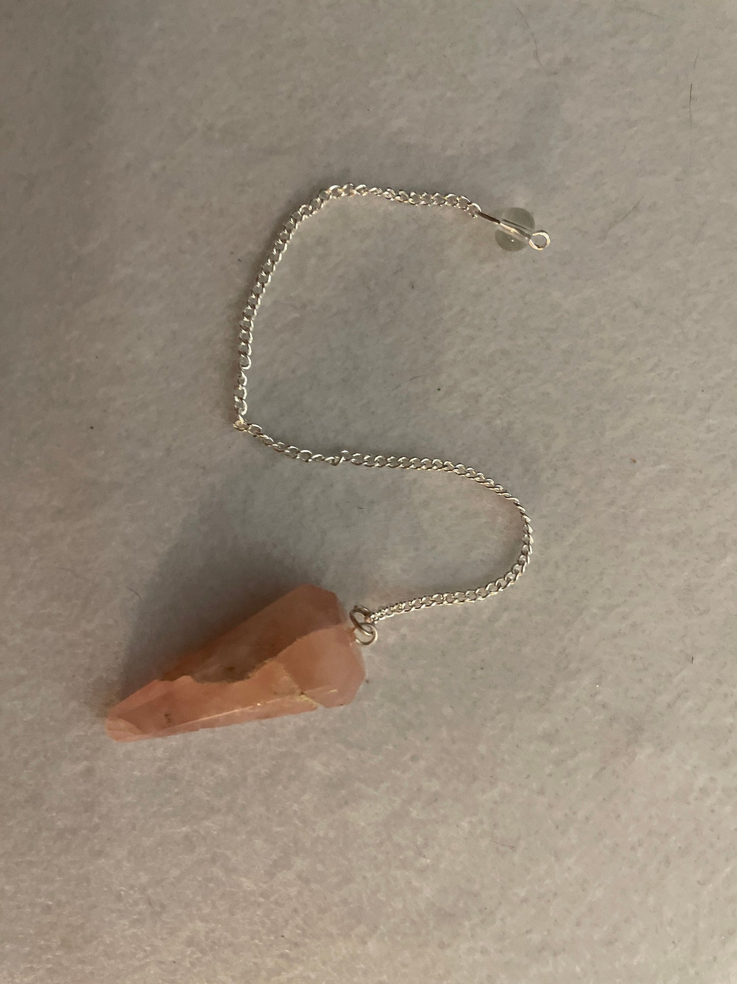 This beautiful Rose Quartz Pendulum is 1.65” and with chain is 8”.