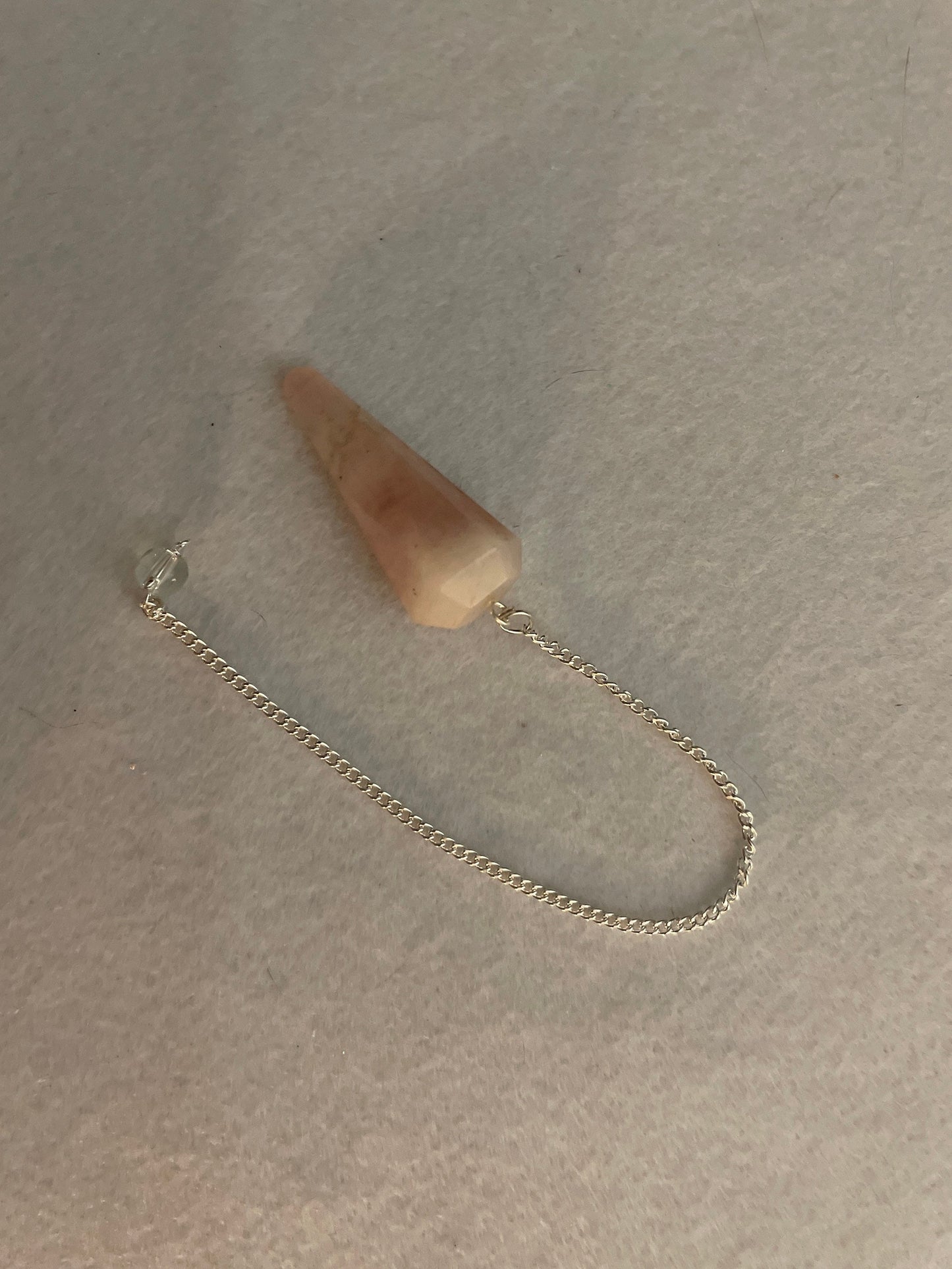 This beautiful Rose Quartz Pendulum is 1.65” and with chain is 8”