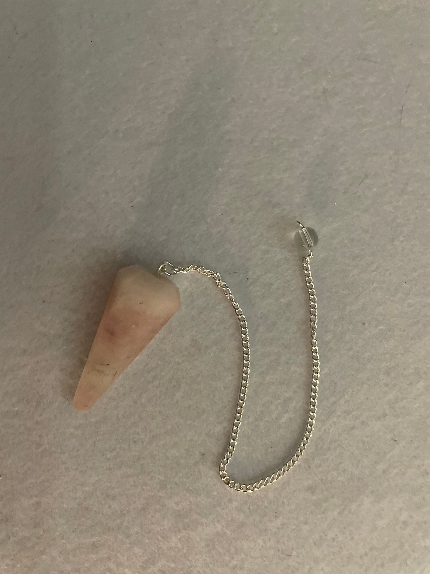 This beautiful Rose Quartz Pendulum is 1.65” and with chain is 8”