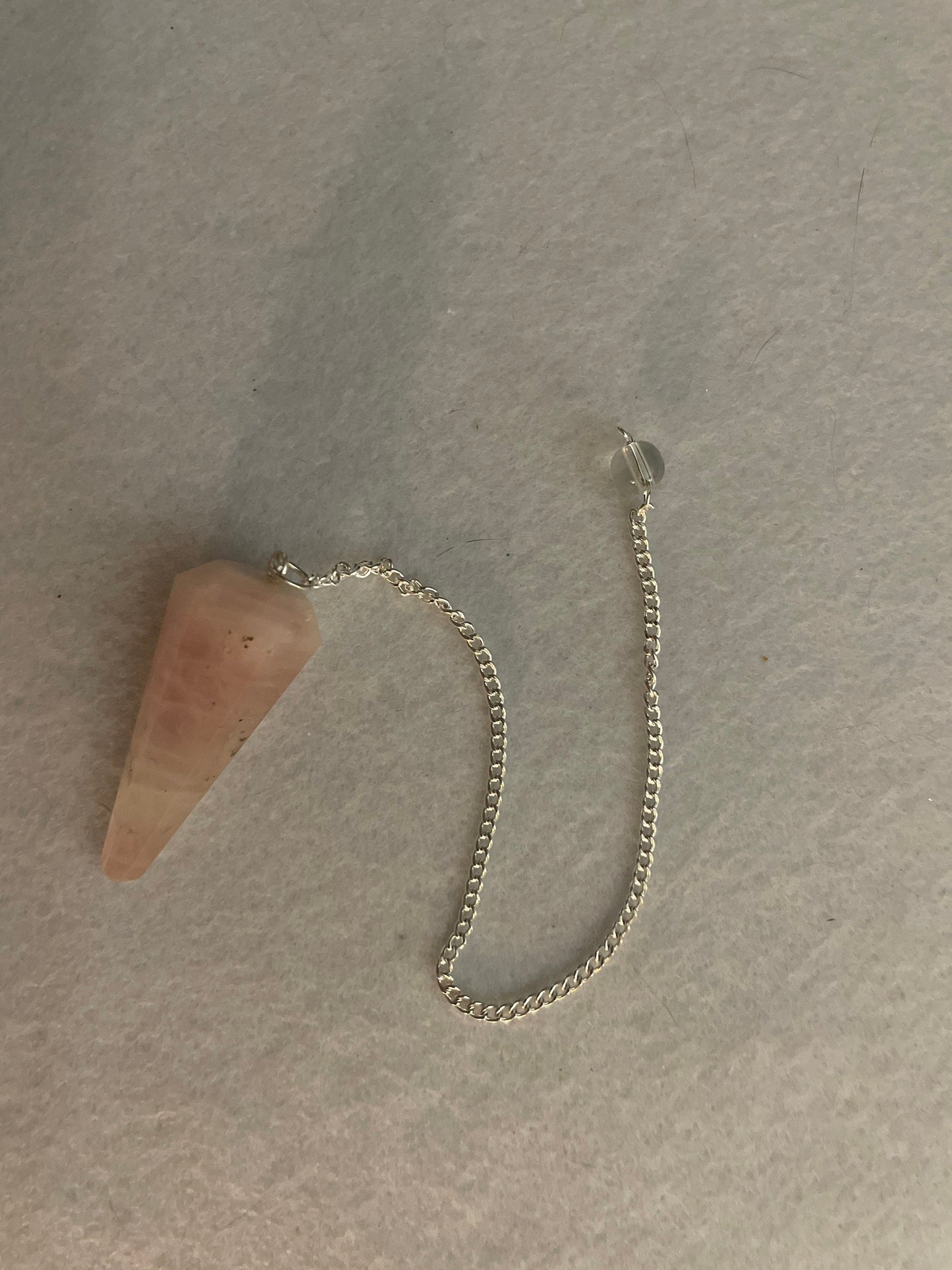 This beautiful Rose Quartz Pendulum is 1.65” and with chain is 8”