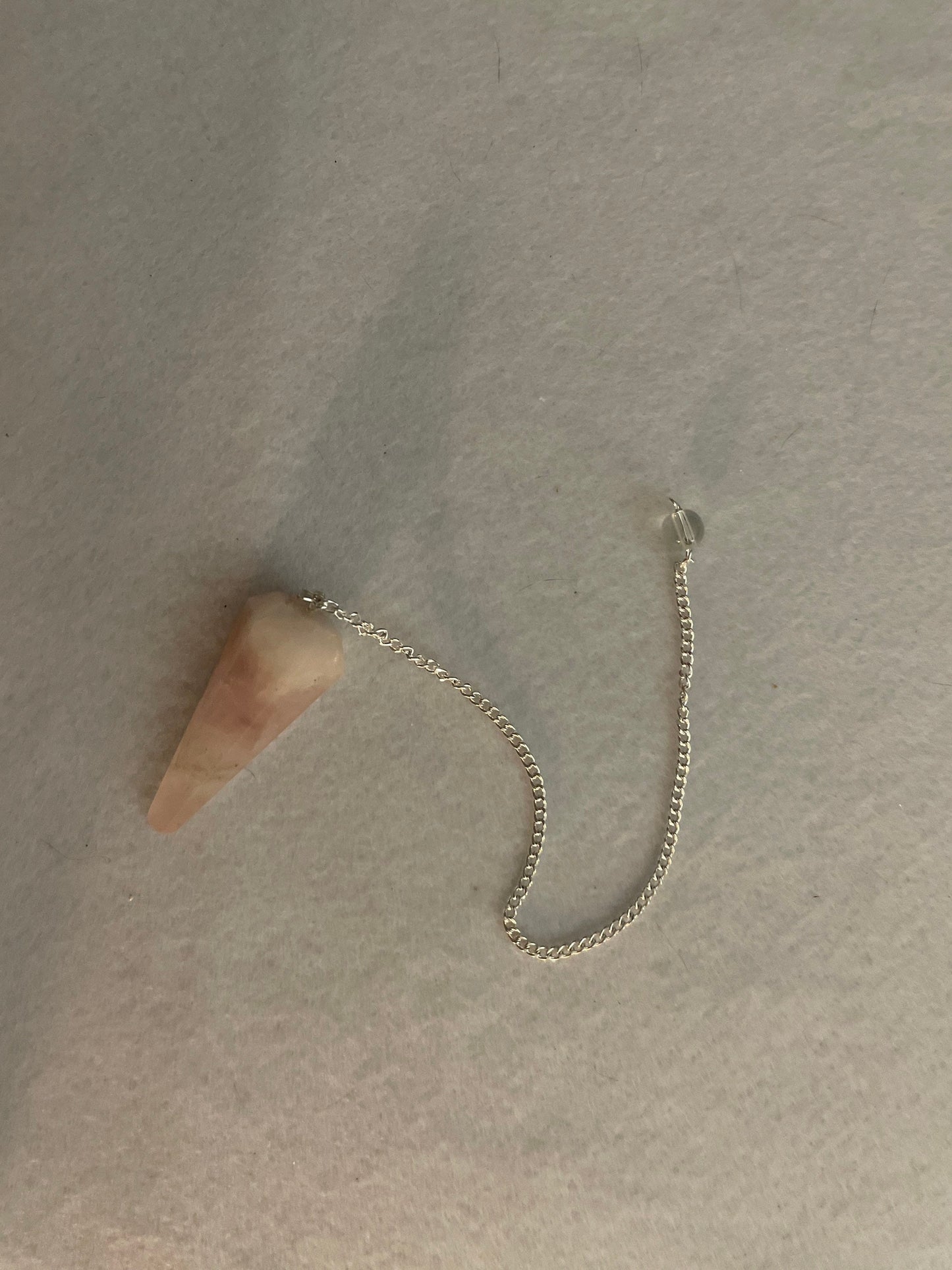 This beautiful Rose Quartz Pendulum is 1.65” and with chain is 8”
