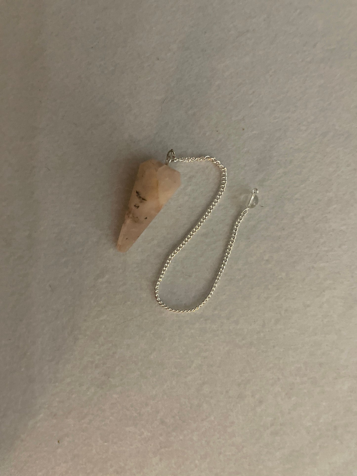 This beautiful Rose Quartz Pendulum is 1.65” and with chain is 8.25”