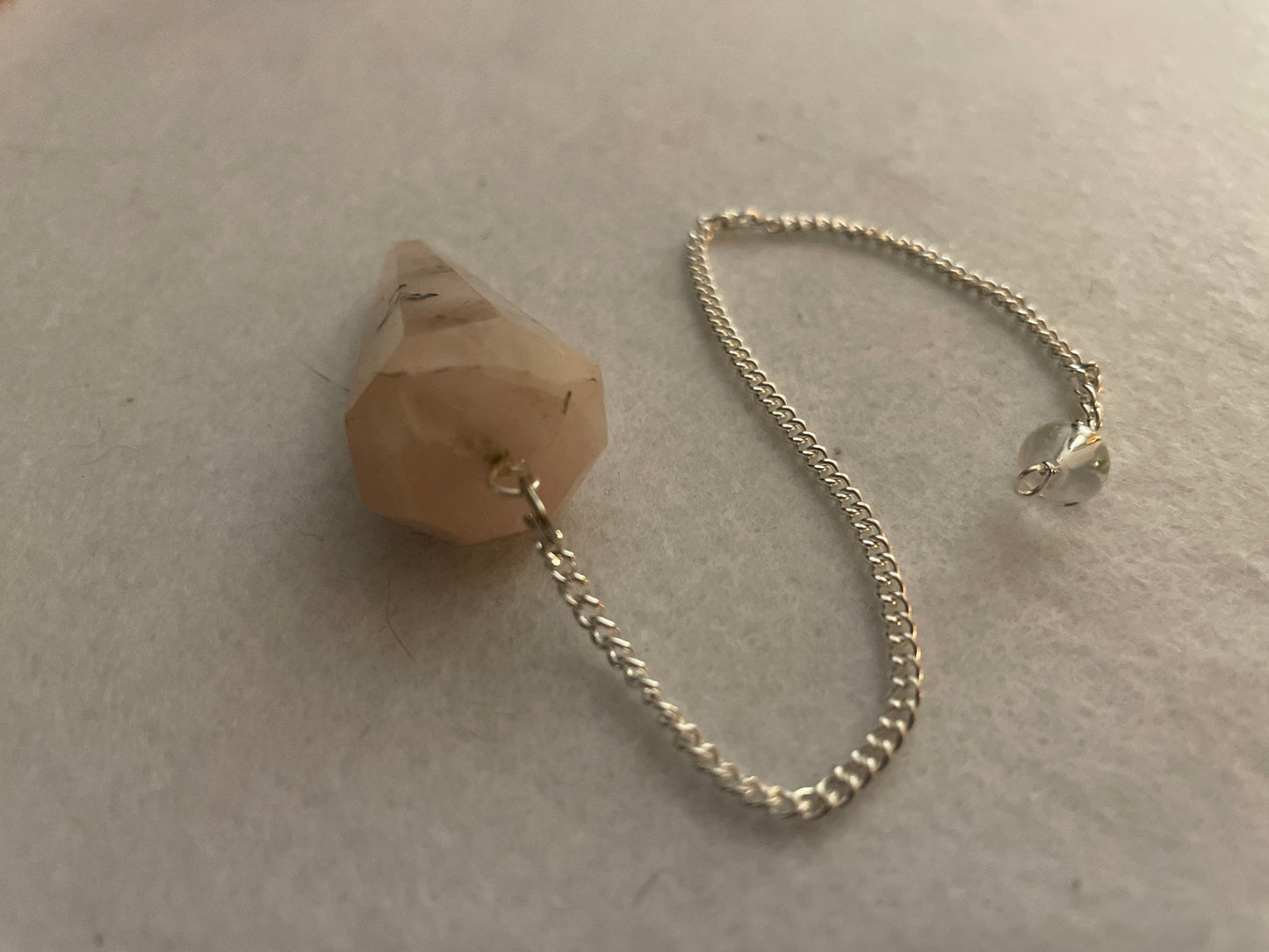 This beautiful Rose Quartz Pendulum is 1.65” and with chain is 8.25”
