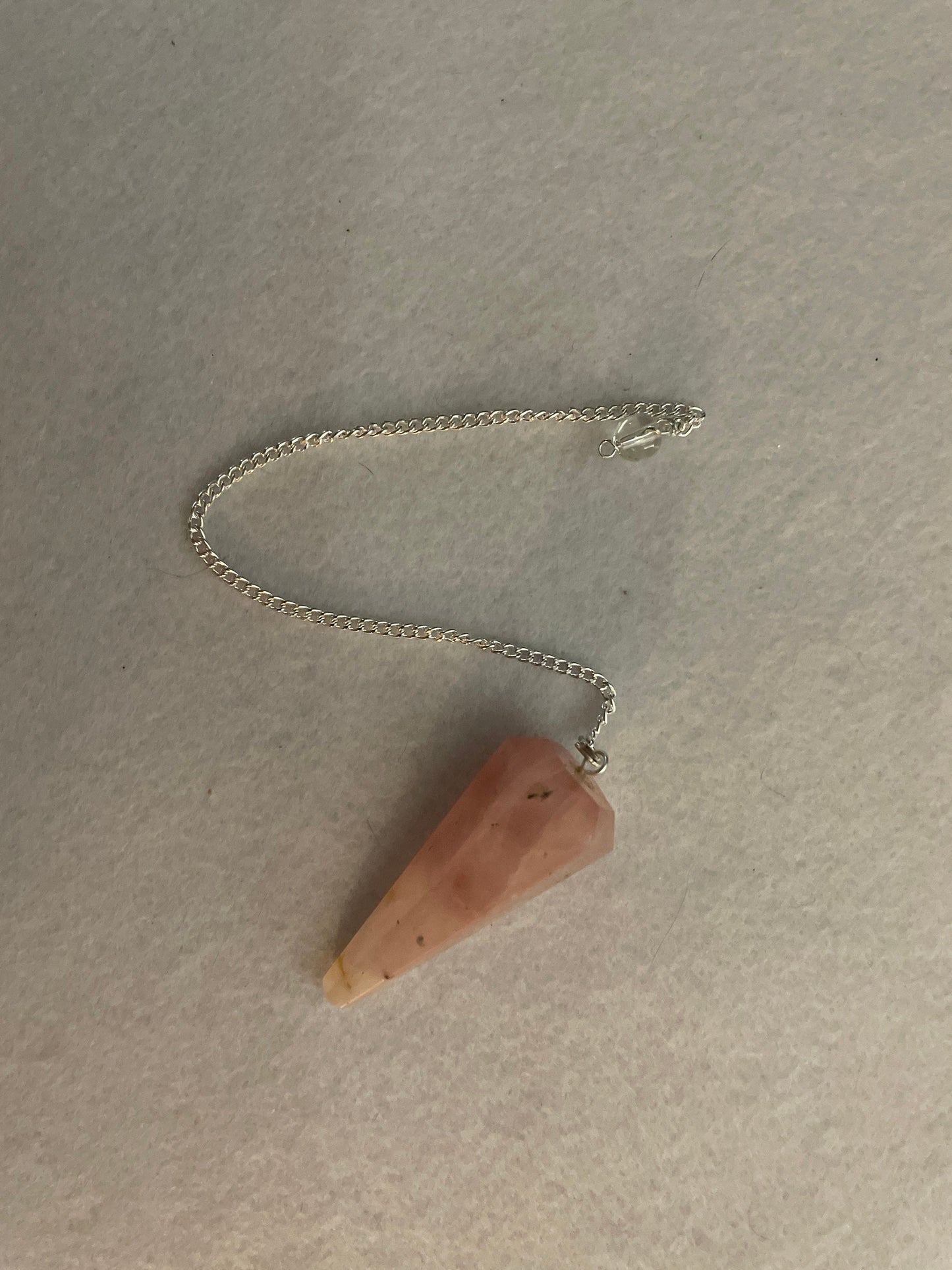 This beautiful Rose Quartz Pendulum is 1.85” and with chain is 8.25”
