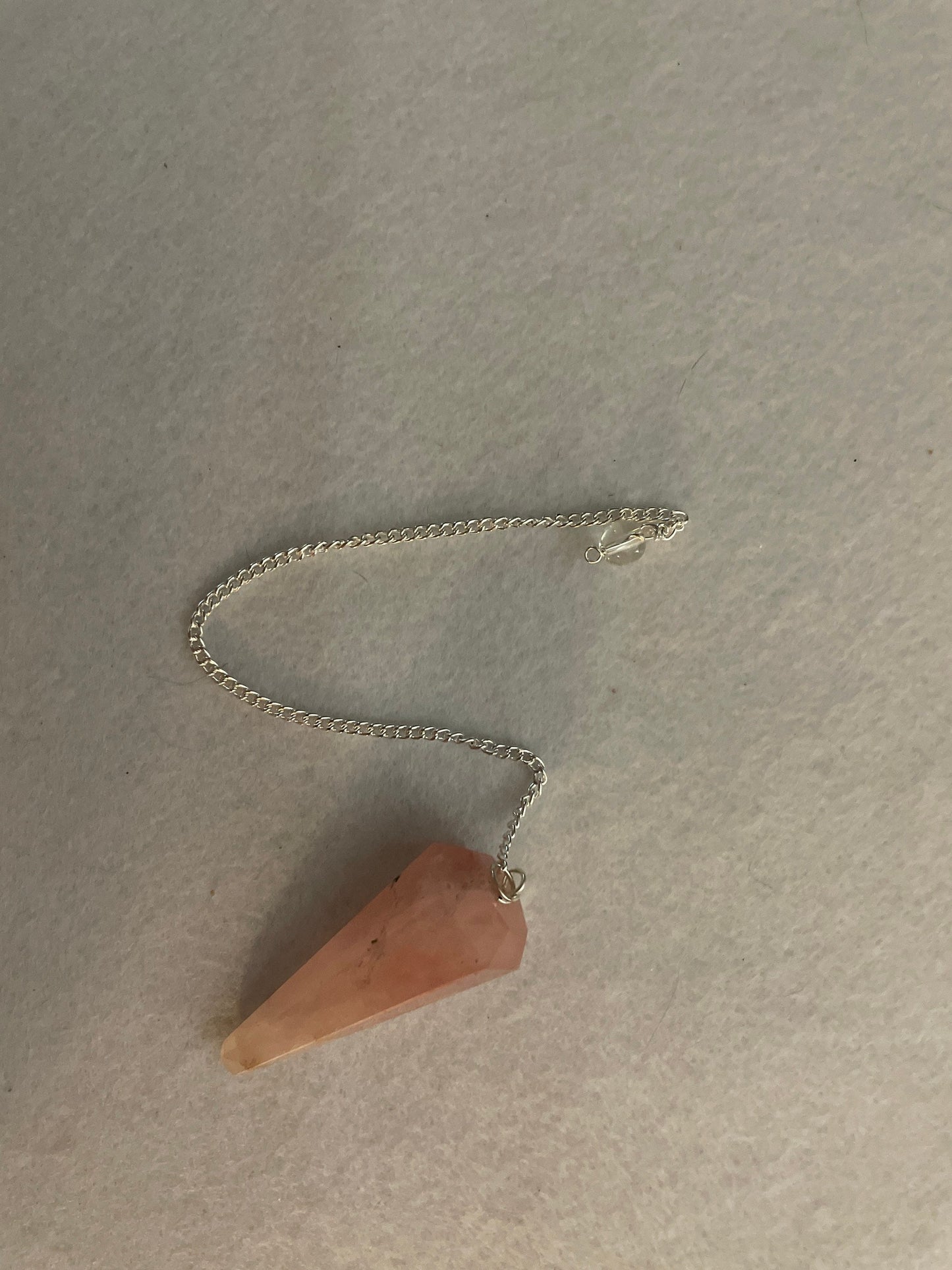 This beautiful Rose Quartz Pendulum is 1.85” and with chain is 8.25”