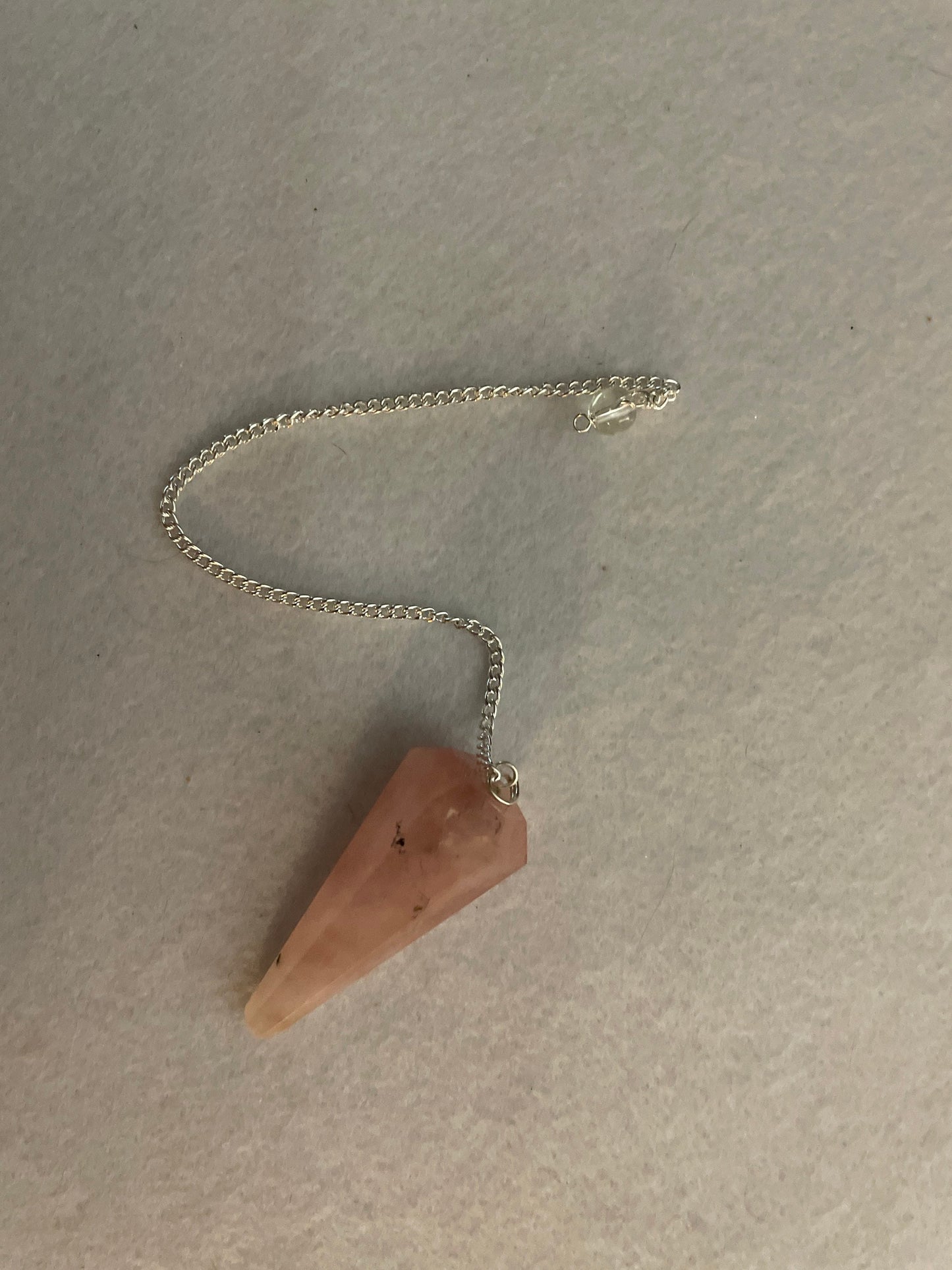 This beautiful Rose Quartz Pendulum is 1.85” and with chain is 8.25”
