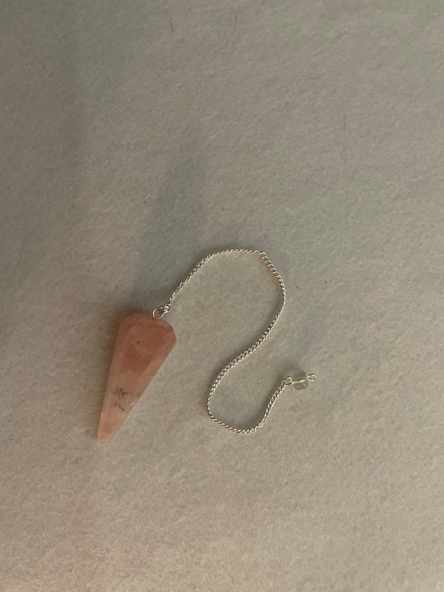 This beautiful Rose Quartz Pendulum is 1.85” and with chain is 8.25”