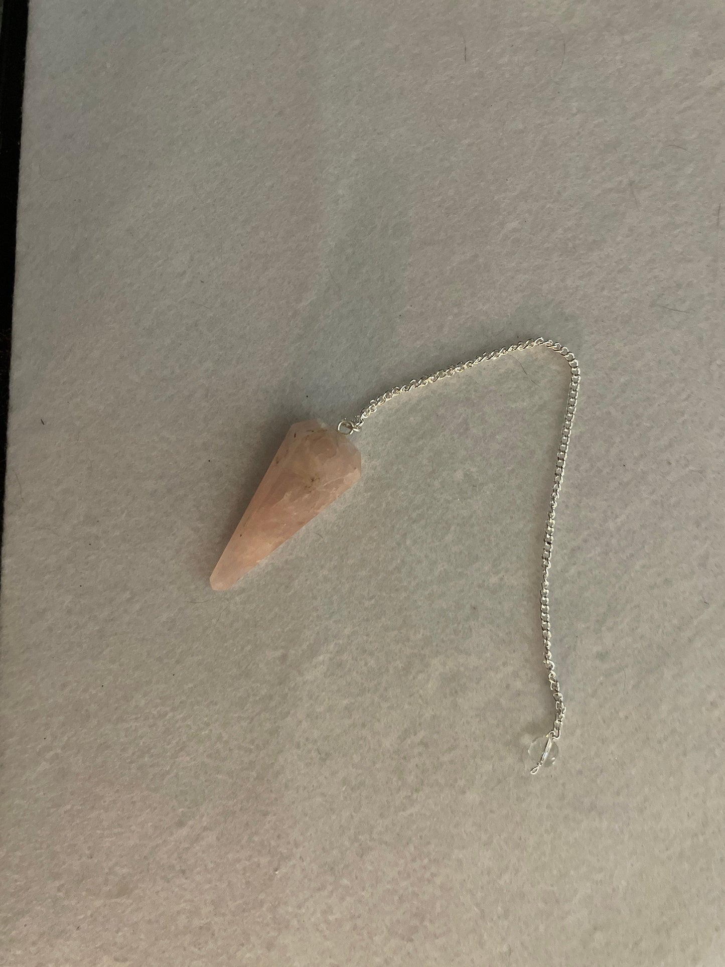 This beautiful Rose Quartz Pendulum is 1.75” and with chain is 8”.
