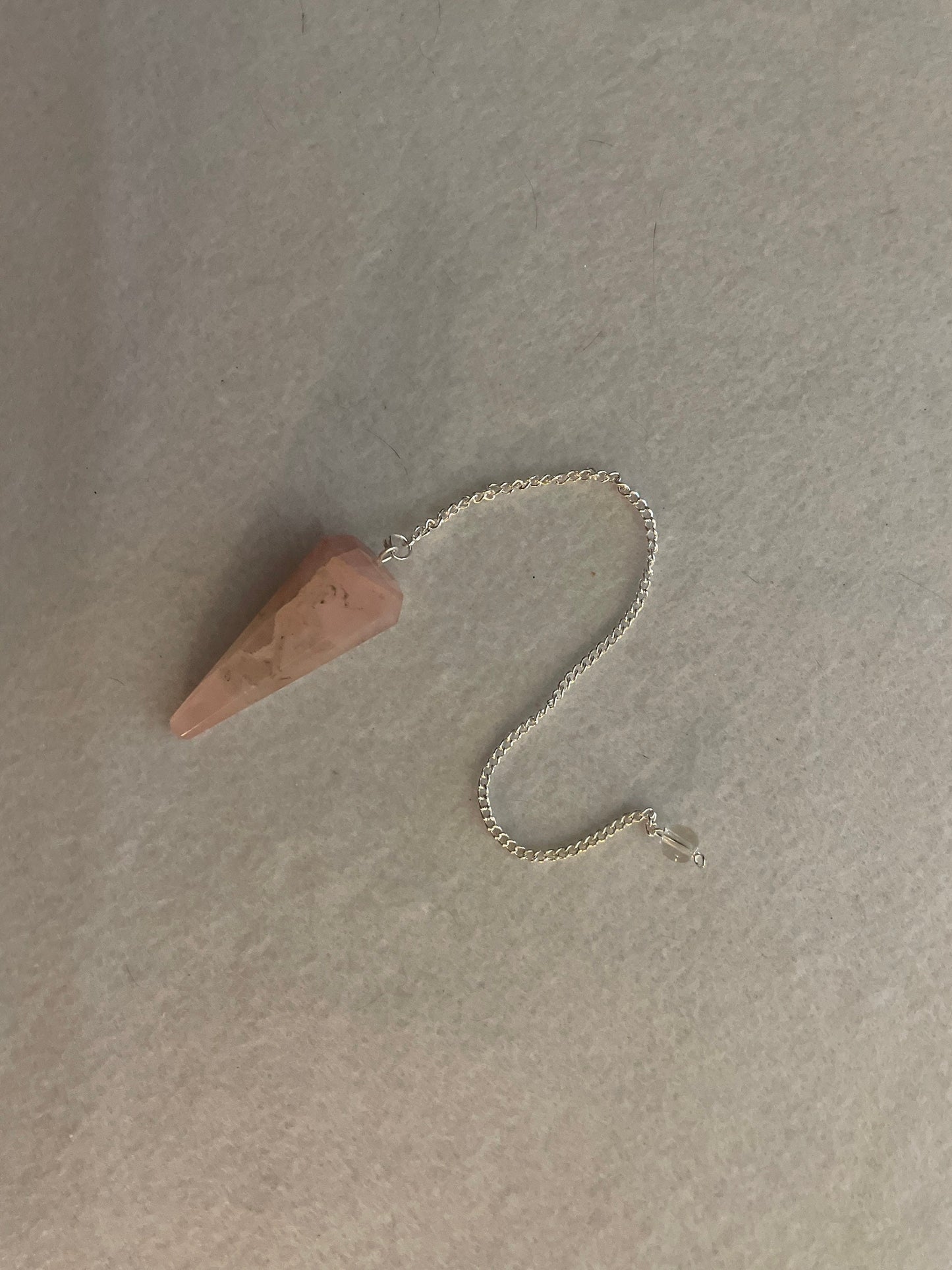 This beautiful Rose Quartz Pendulum is 1.75” and with chain is 8.25”