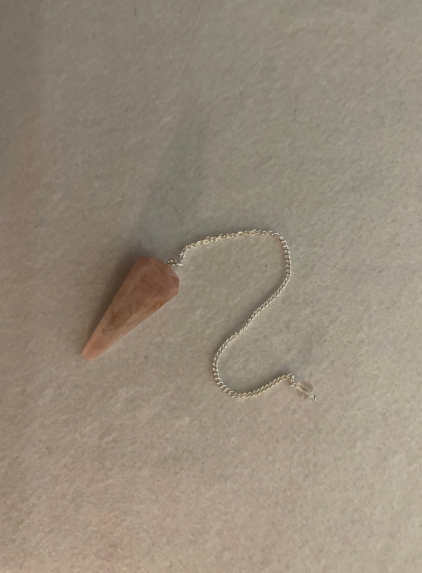 This beautiful Rose Quartz Pendulum is 1.75” and with chain is 8.25”