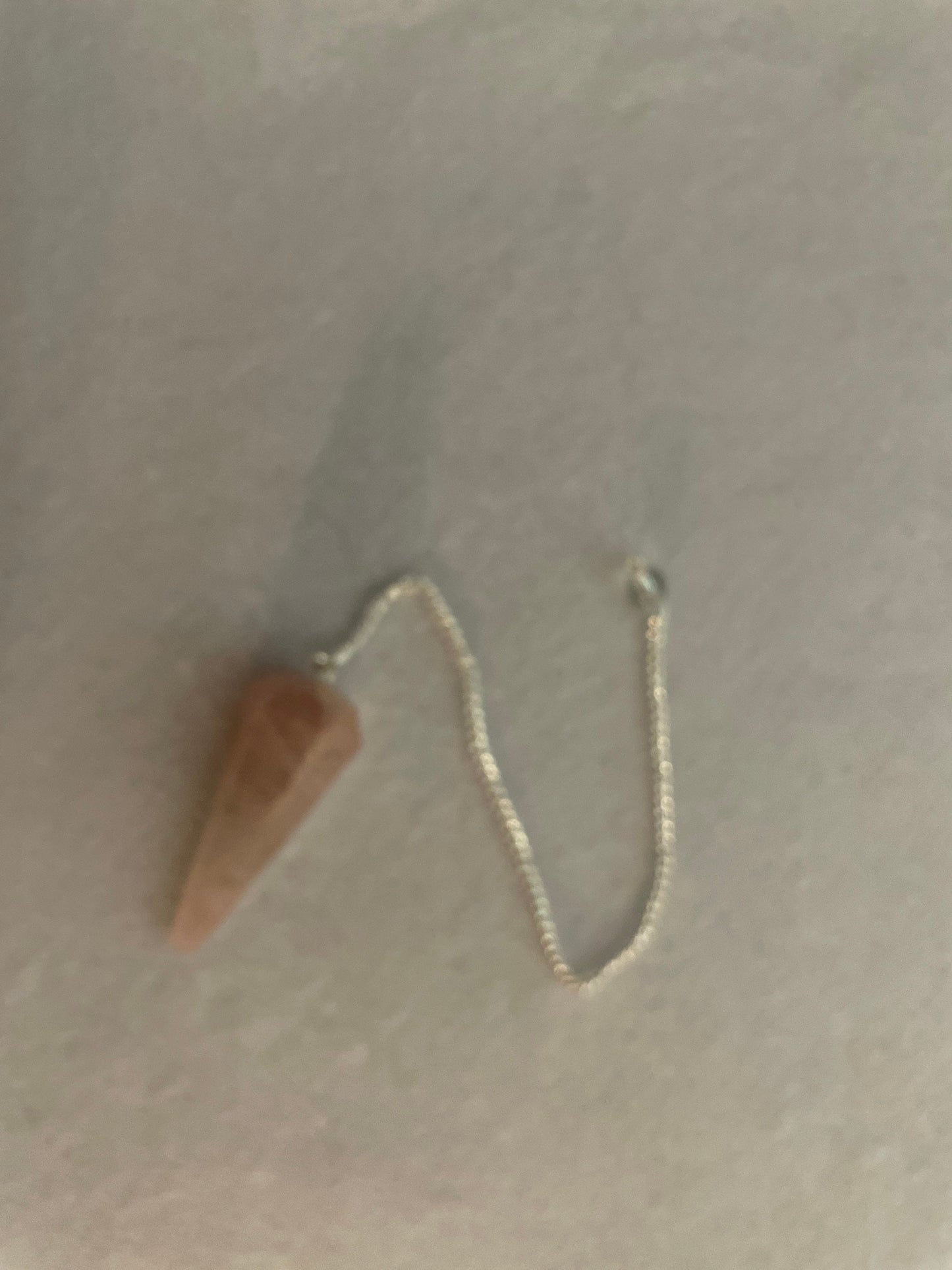 This beautiful Rose Quartz Pendulum is 1.75” and with chain is 8.25”