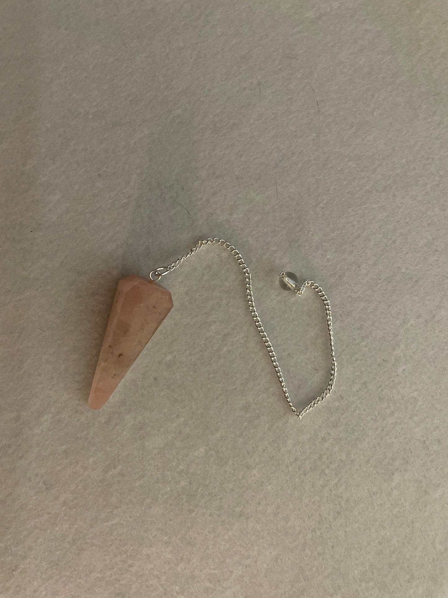 This beautiful Rose Quartz Pendulum is 1.75” and with chain is 8.25”