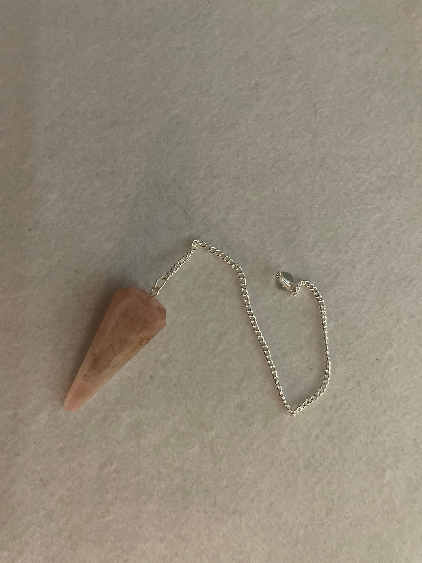 This beautiful Rose Quartz Pendulum is 1.75” and with chain is 8.25”