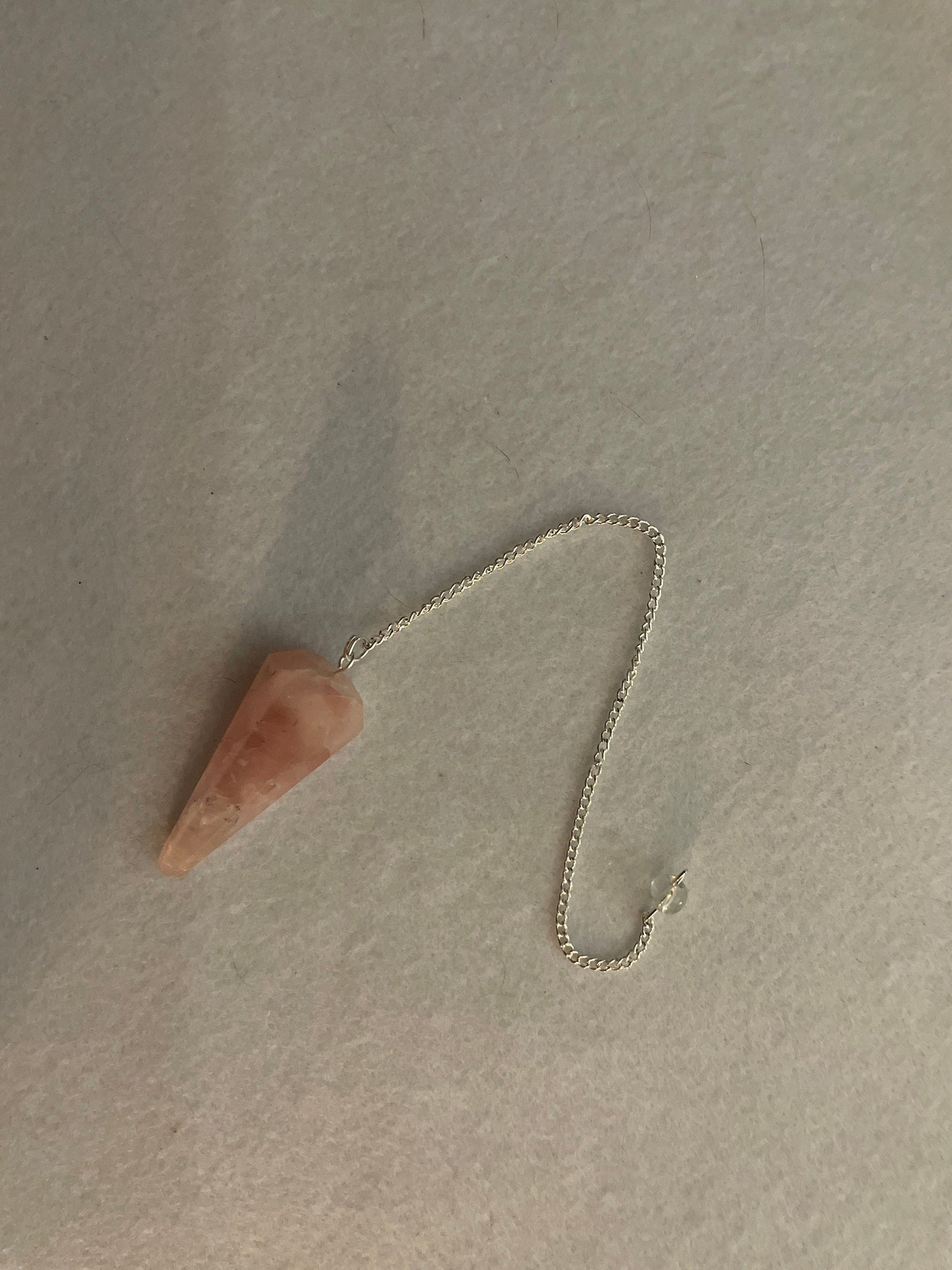 This beautiful Rose Quartz Pendulum is 1.75” and with chain is 8.25”