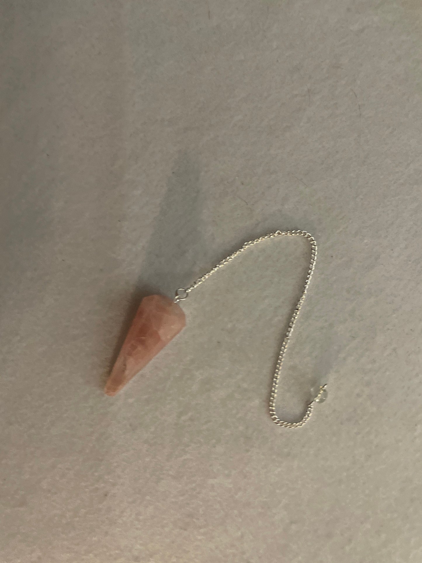 This beautiful Rose Quartz Pendulum is 1.75” and with chain is 8.25”
