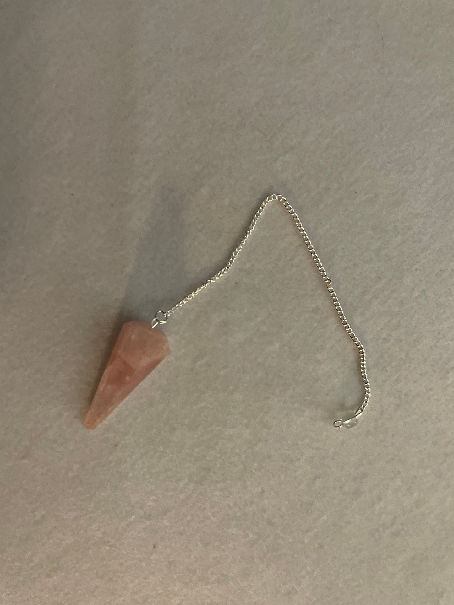 This beautiful Rose Quartz Pendulum is 1.75” and with chain is 8.25”