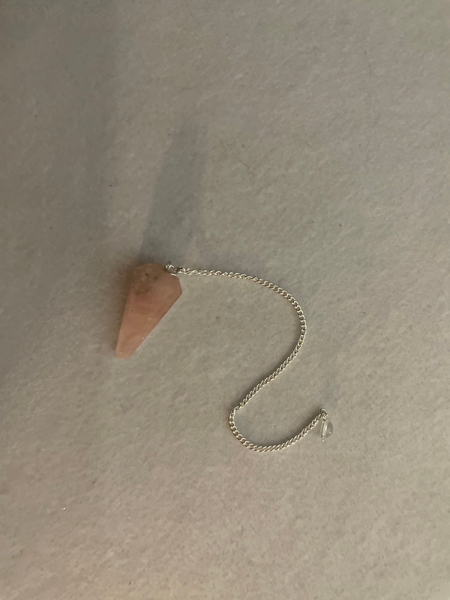 This beautiful Rose Quartz Pendulum is 1.5” and with chain is 8”