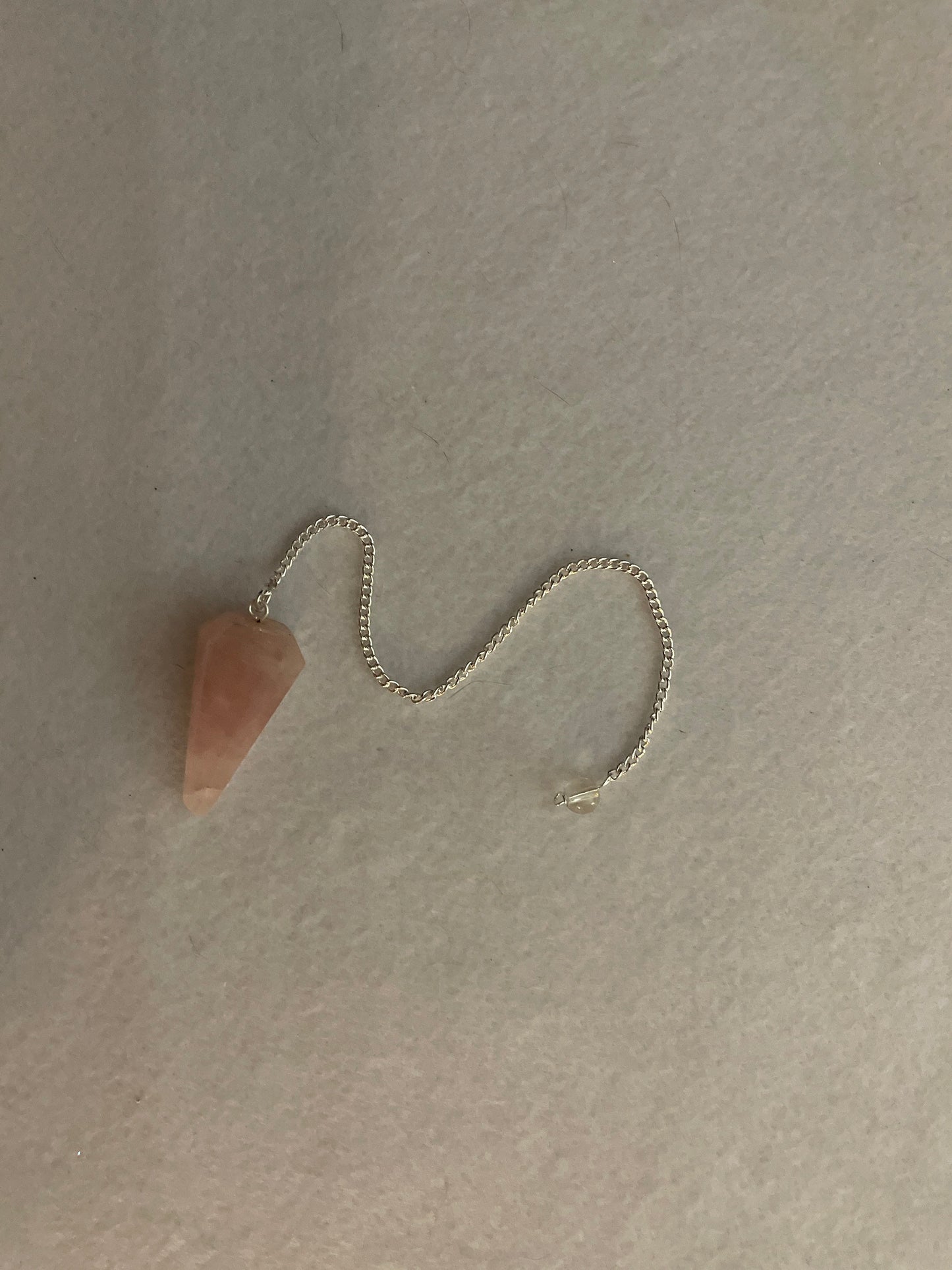 This beautiful Rose Quartz Pendulum is 1.5” and with chain is 8”