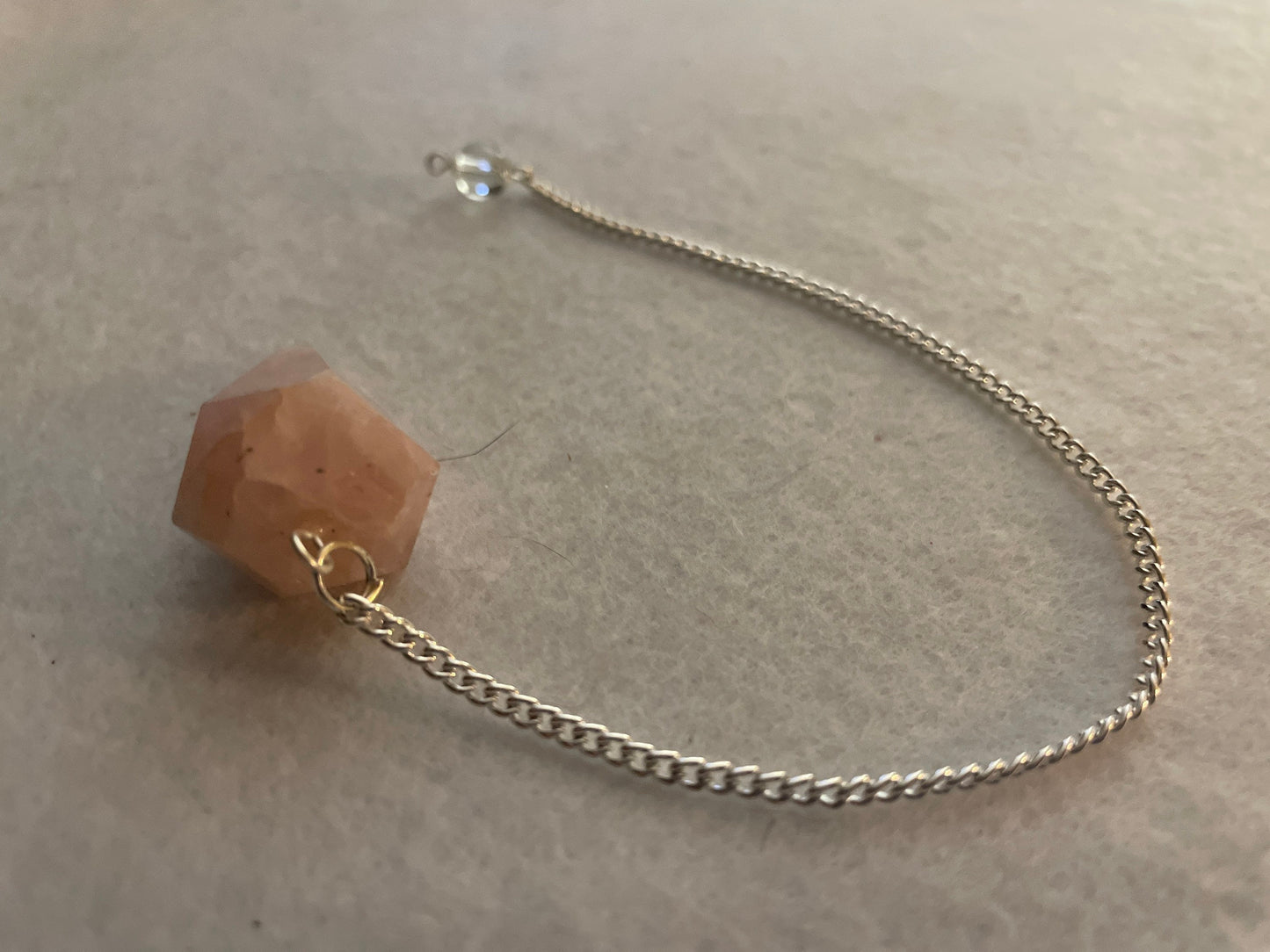 This beautiful Rose Quartz Pendulum is 1.35” and with chain is 8”