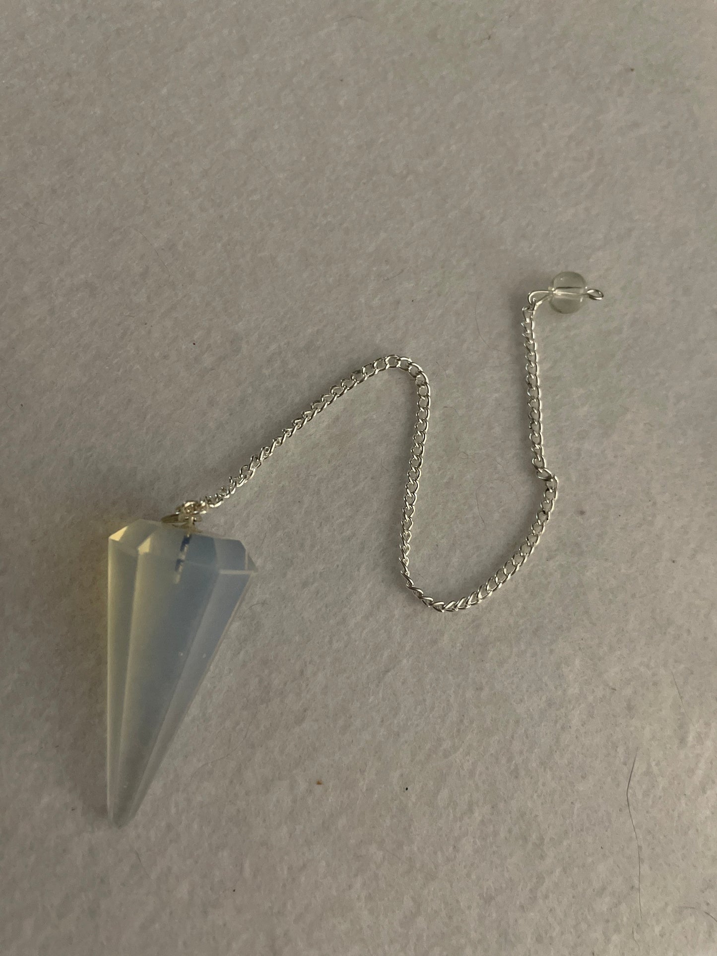 This beautiful  Opalite pendulum is approximately 1.5” and with chain is 8.25”