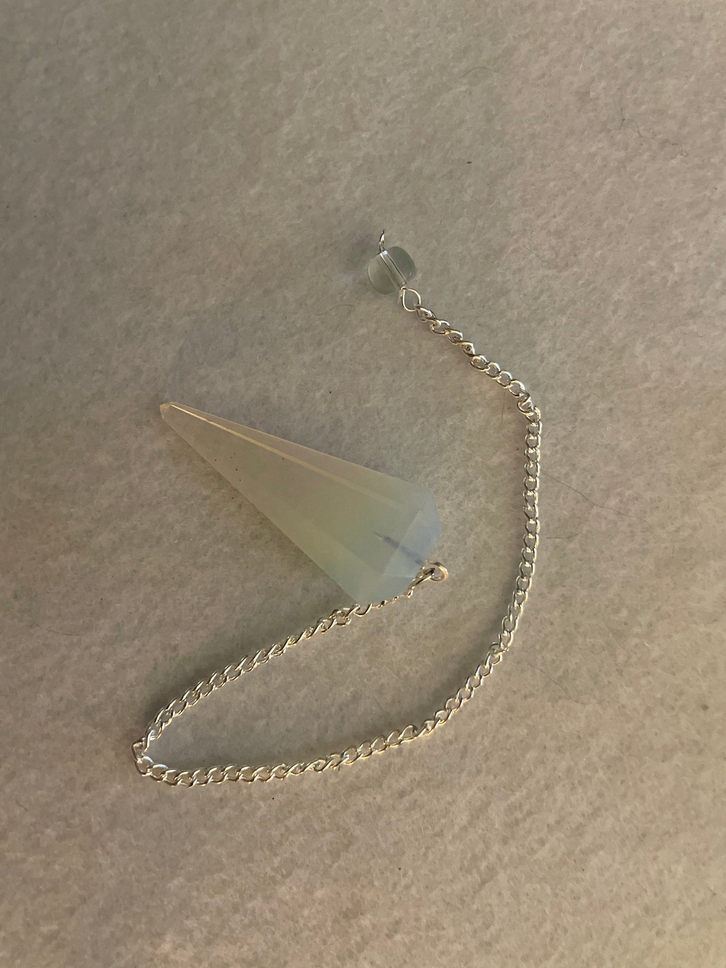 This beautiful  Opalite pendulum is approximately 1.65” and with chain is 8.5”