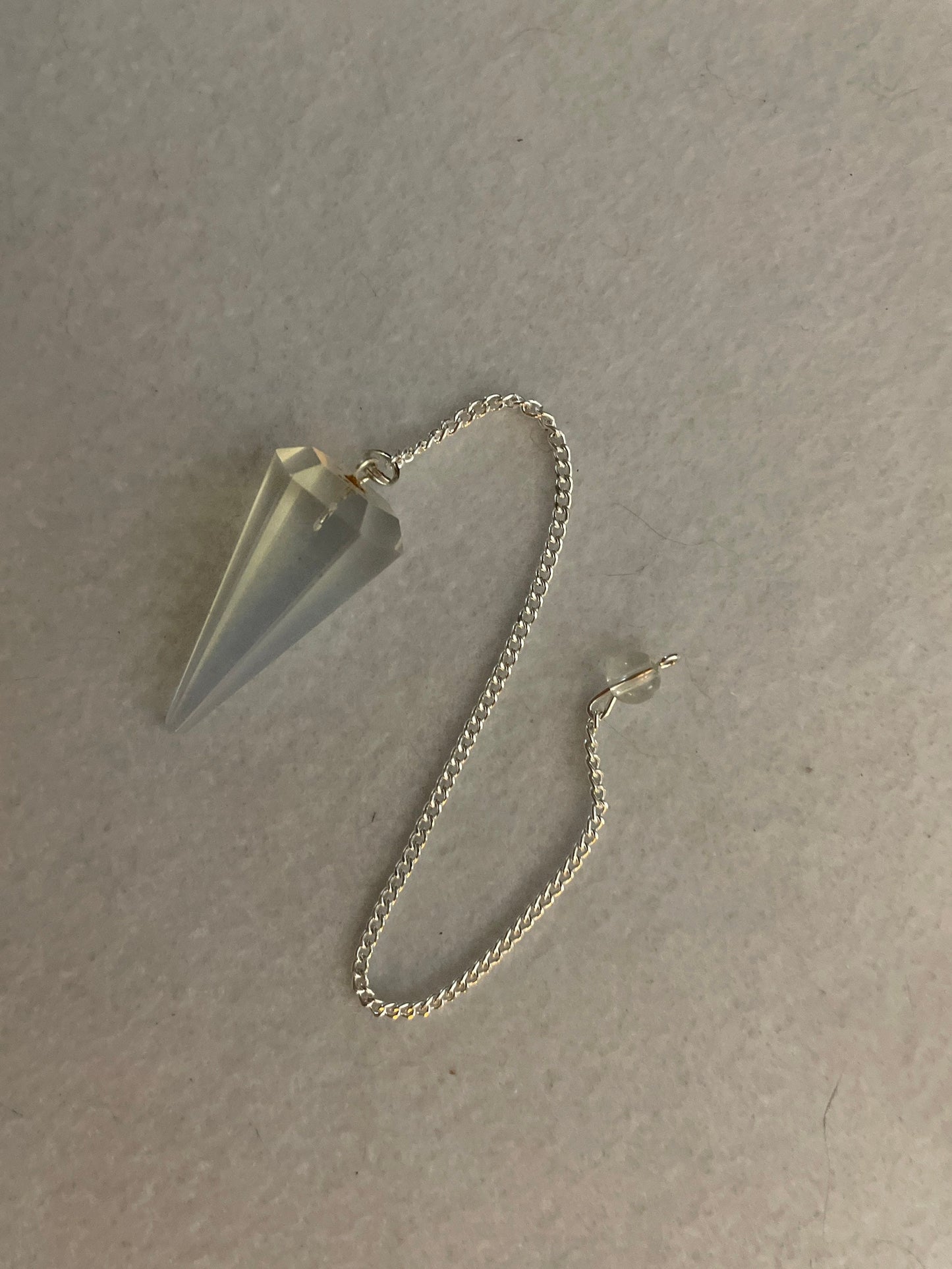 This beautiful  Opalite pendulum is approximately 1.65” and with chain is 8.5”