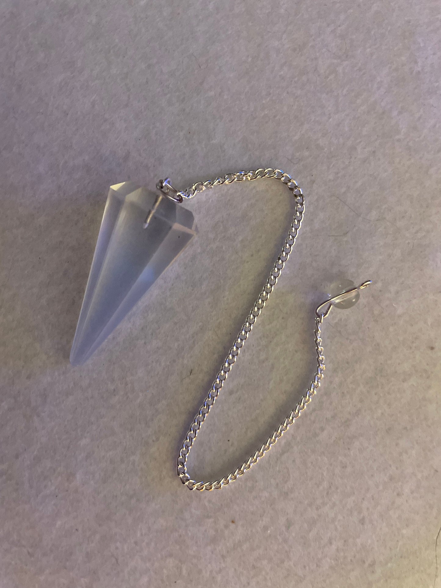 This beautiful  Opalite pendulum is approximately 1.65” and with chain is 8.5”