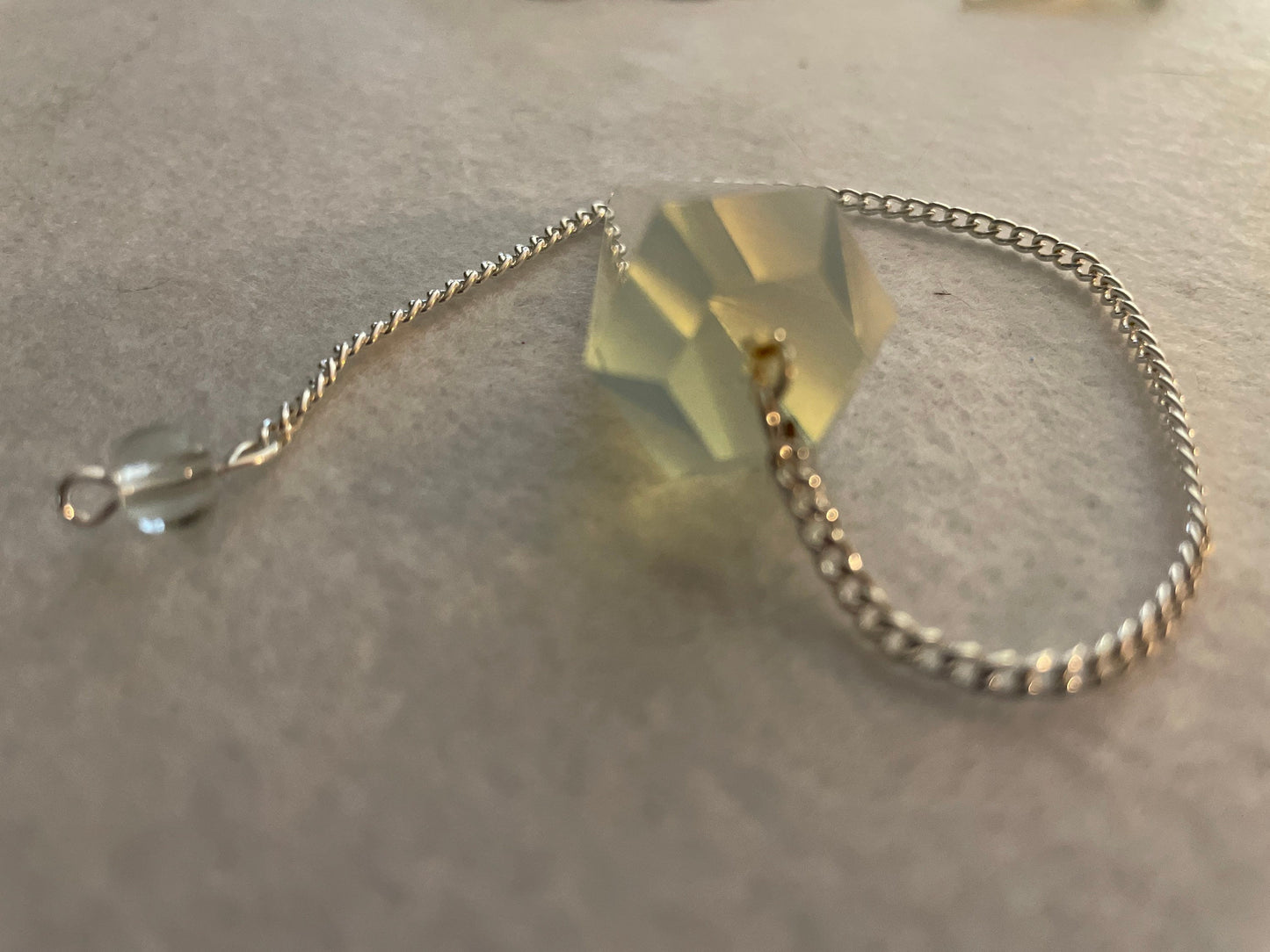 This beautiful  Opalite pendulum is approximately 1.65” and with chain is 8.5”