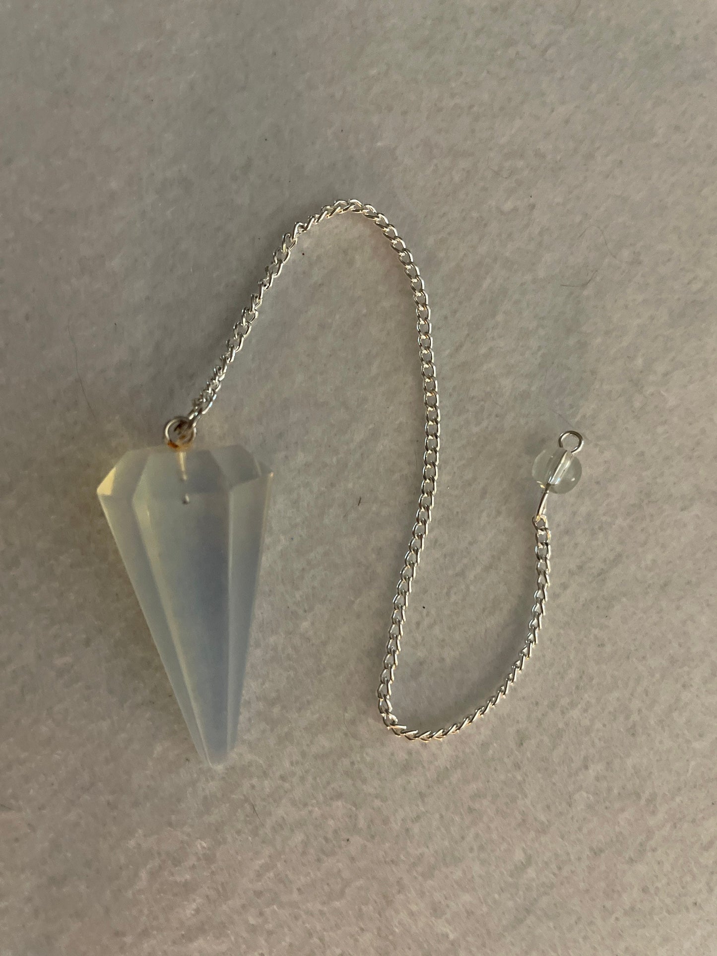 This beautiful  Opalite pendulum is approximately 1.65” and with chain is 8.5”