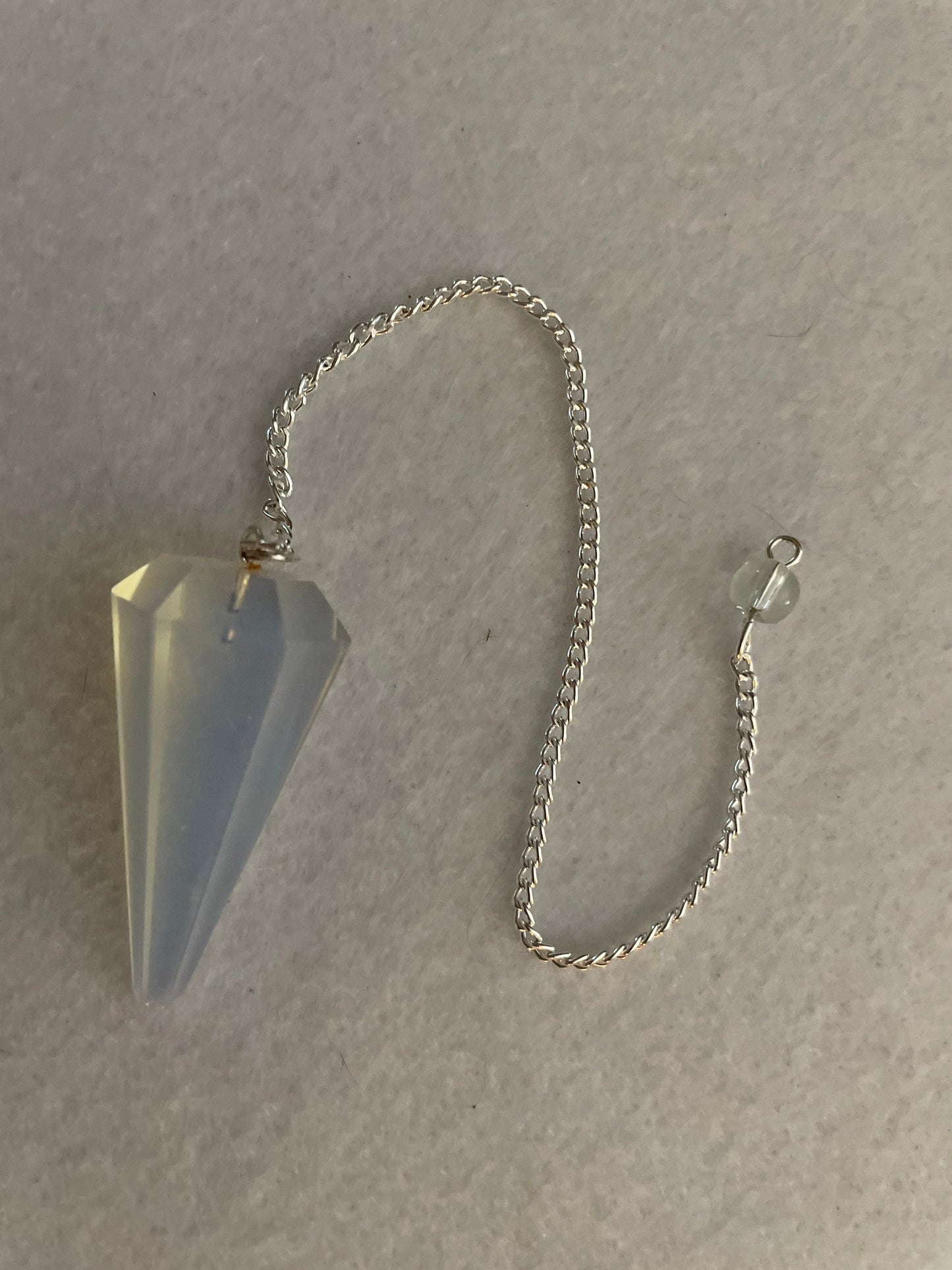 This beautiful  Opalite pendulum is approximately 1.65” and with chain is 8.5”