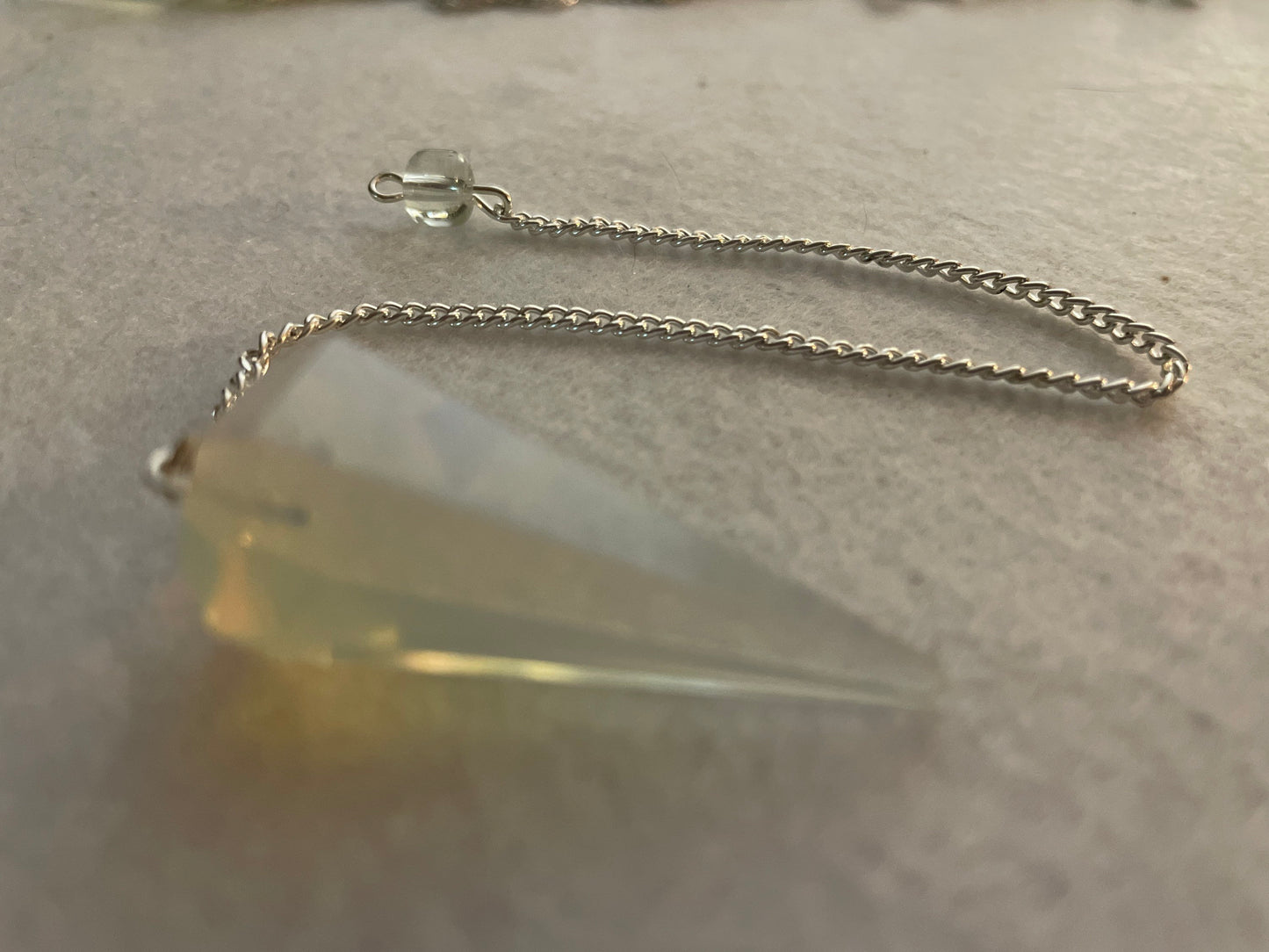 This beautiful  Opalite pendulum is approximately 1.65” and with chain is 8.5”