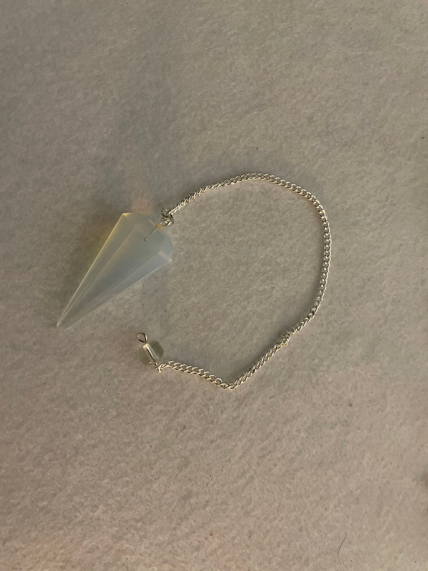 This beautiful  Opalite pendulum is approximately 1.65” and with chain is 8.5”