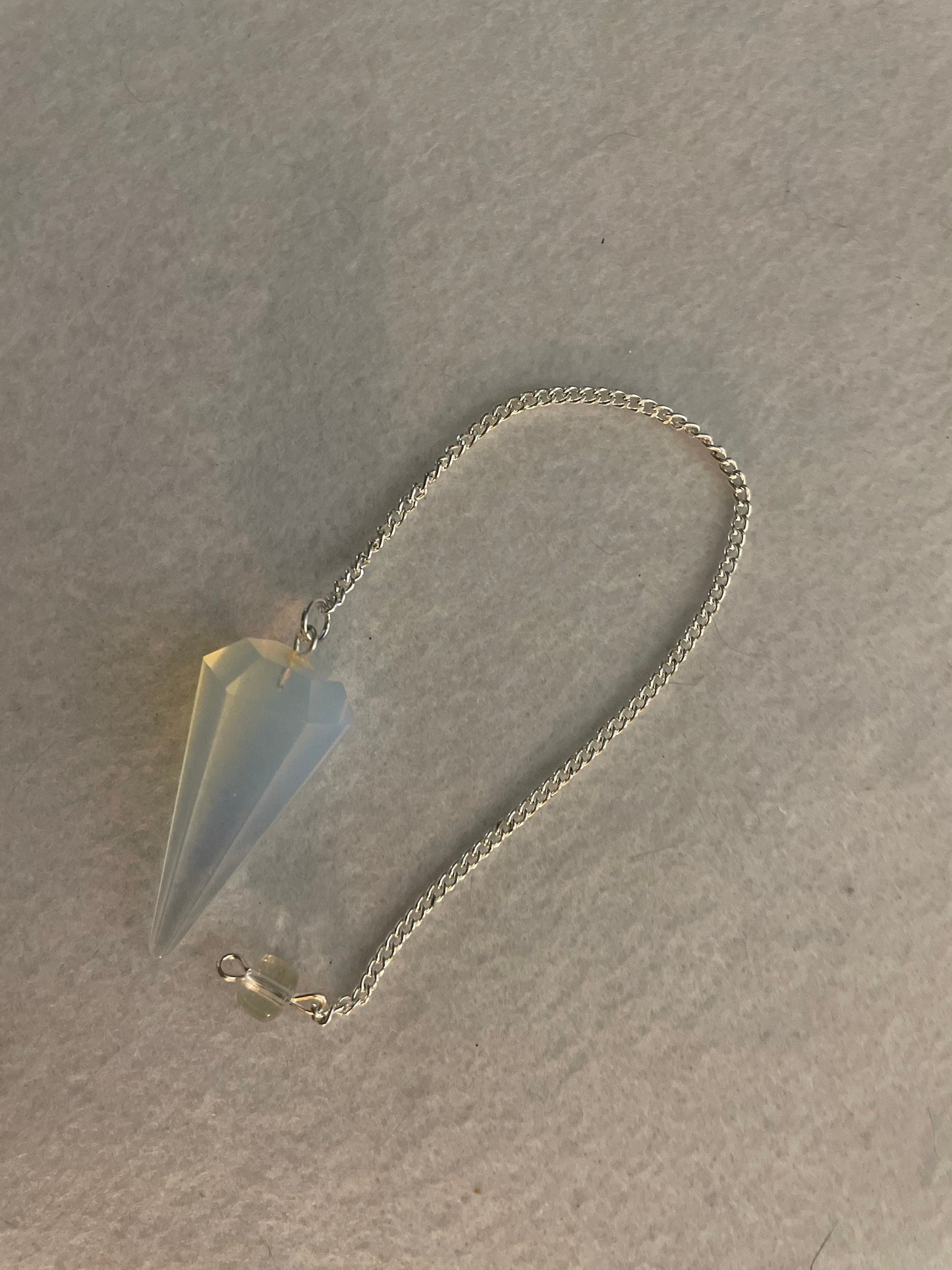 This beautiful  Opalite pendulum is approximately 1.65” and with chain is 8.5”