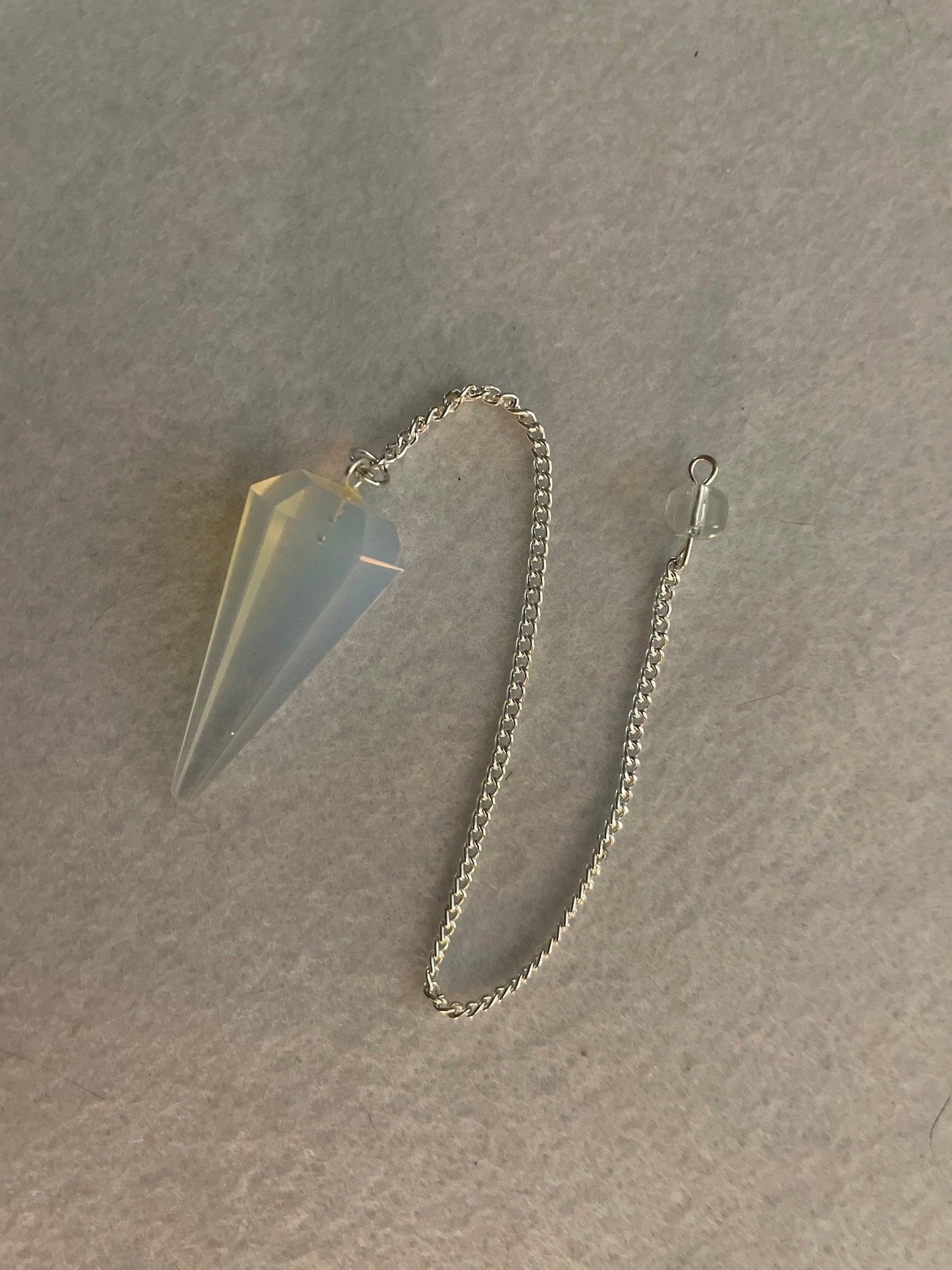 This beautiful  Opalite pendulum is approximately 1.65” and with chain is 8.5”