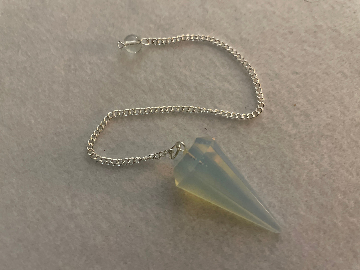 This beautiful  Opalite pendulum is approximately 1.65” and with chain is 8.5”