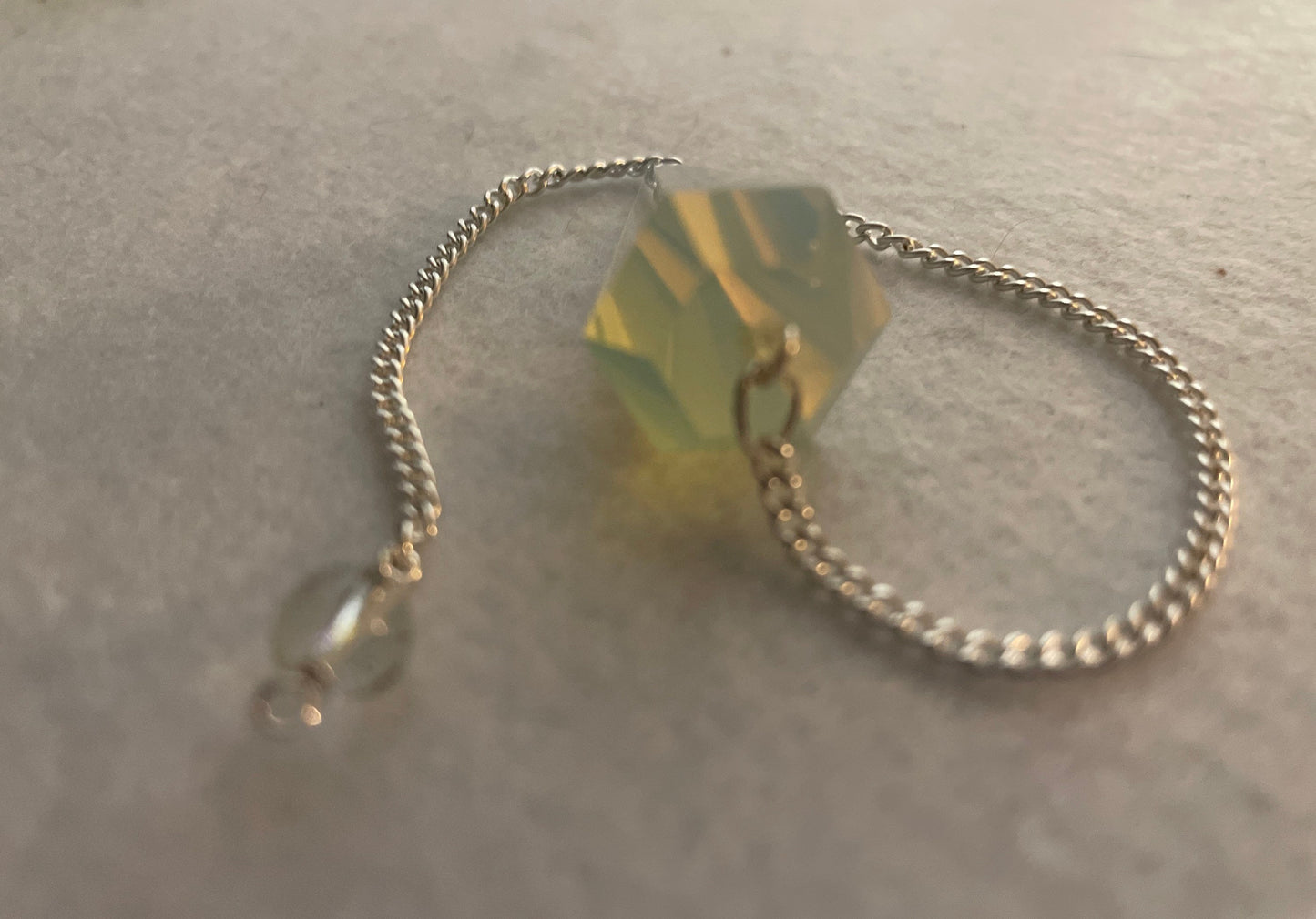 This beautiful  Opalite pendulum is approximately 1.65” and with chain is 8.5”