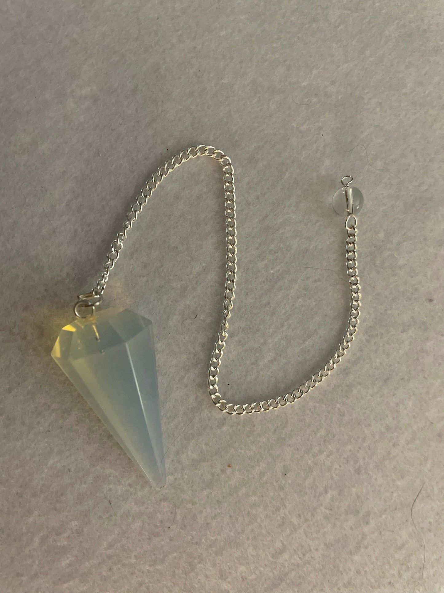 This beautiful  Opalite pendulum is approximately 1.65” and with chain is 8.5”