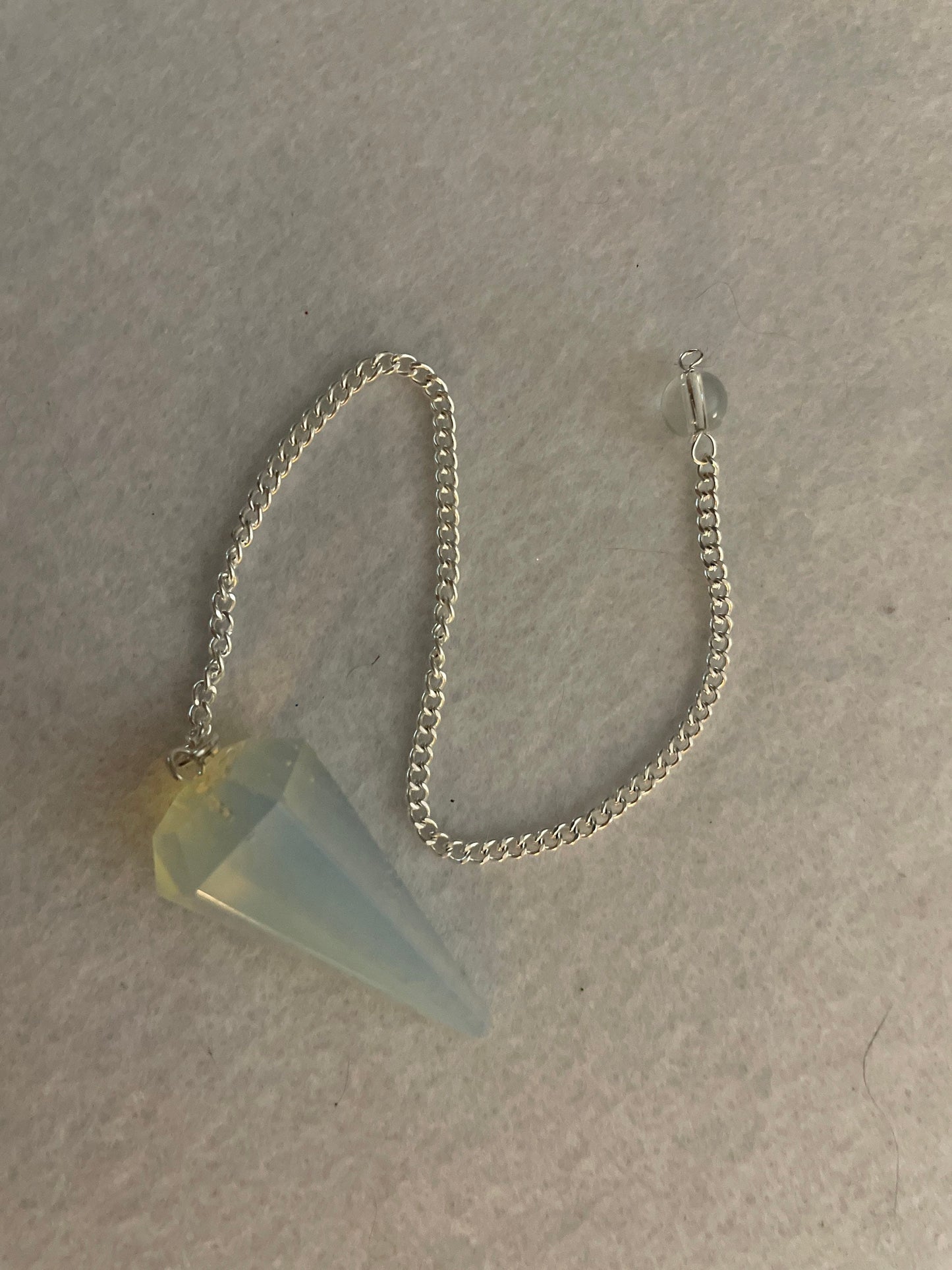 This beautiful  Opalite pendulum is approximately 1.65” and with chain is 8.5”