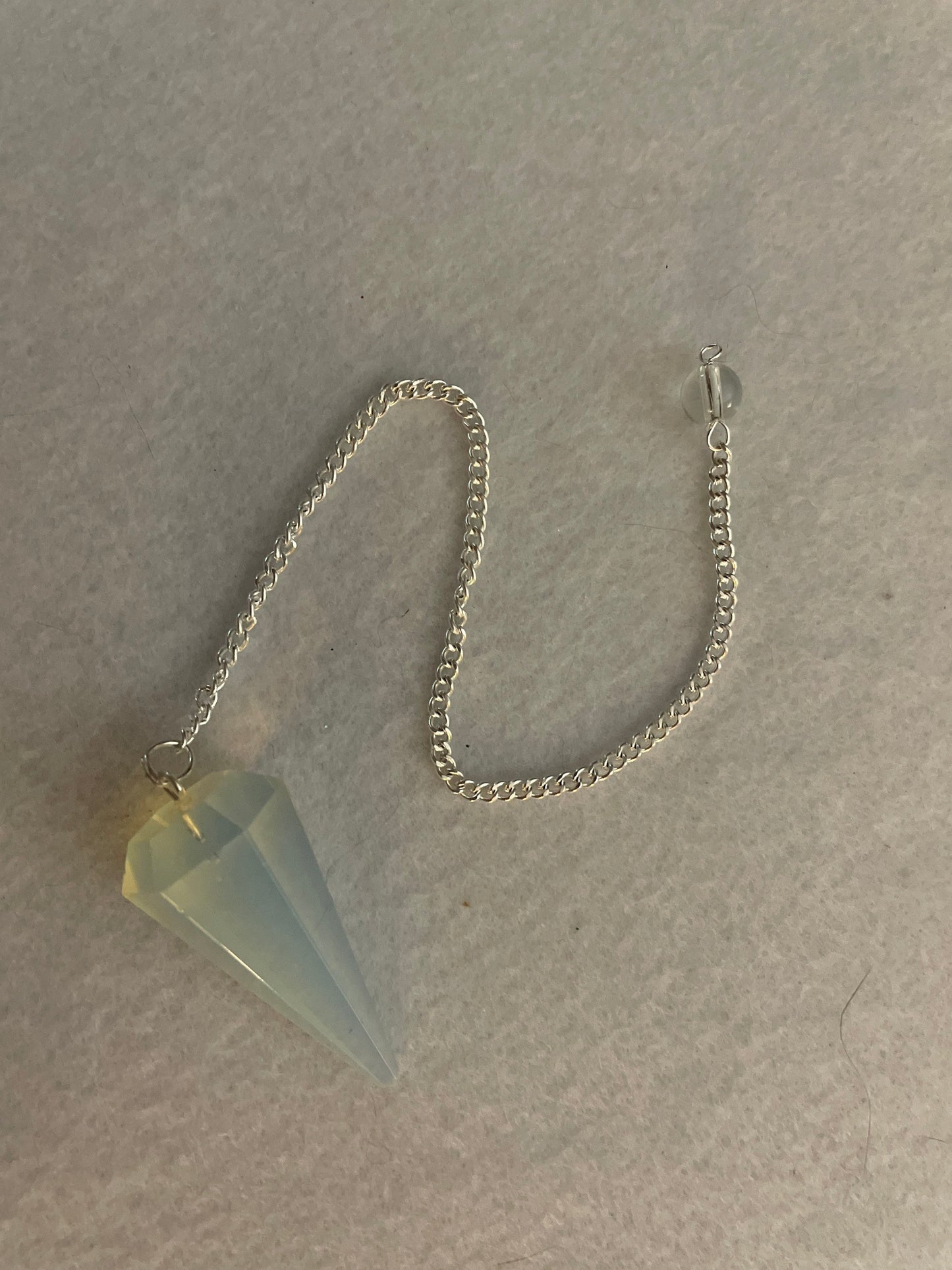 This beautiful  Opalite pendulum is approximately 1.65” and with chain is 8.5”