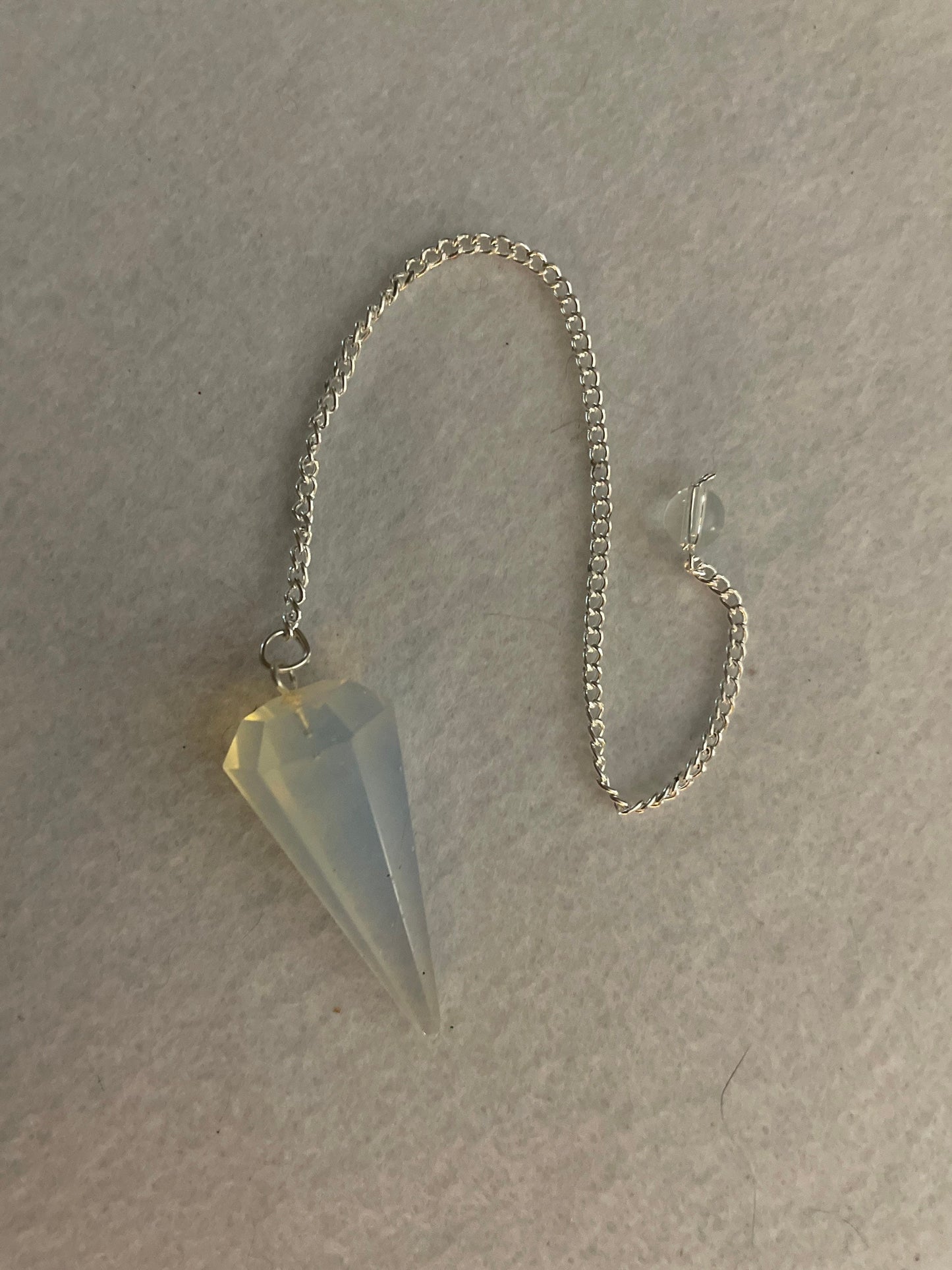 This beautiful  Opalite pendulum is approximately 1.65” and with chain is 8.5”